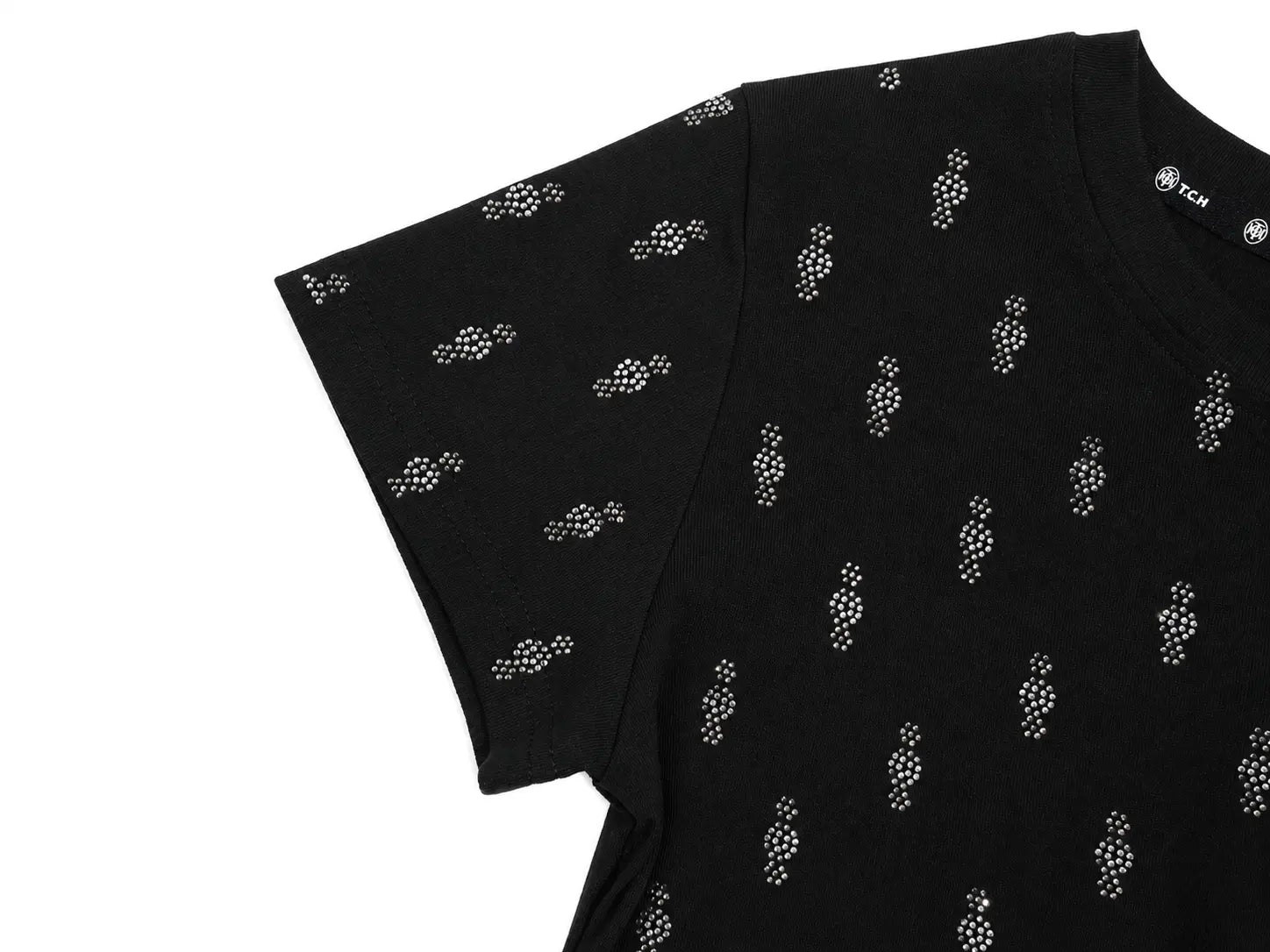 A close-up of a black short-sleeve t-shirt featuring a repeating pattern of small white dotted figures, with a visible 'FCM' brand label on the inner neck. TCH Rhinestone Techno Cross Graphic Black T-Shirt