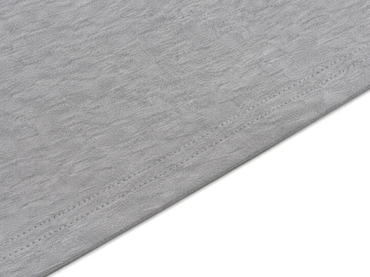Close-up of a light gray heathered fabric with a neat hem and fine stitching, shown against a white background. TCH Rhinestone Techno Unicorn Graphic T-Shirt