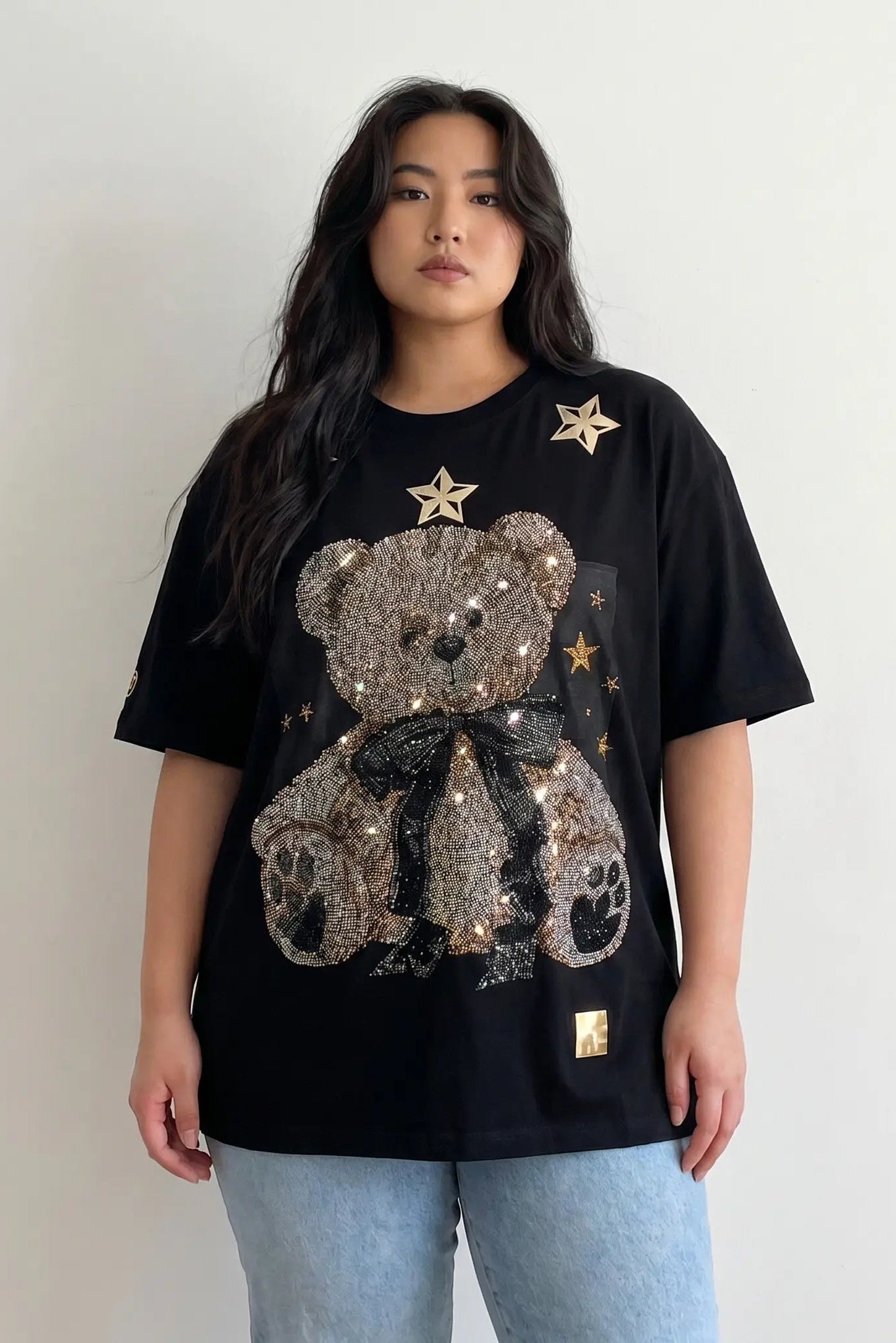 Person wearing a black t-shirt with a sequined bear design on a plain background, TCH Rhinestone Teddy Bear Black T-Shirt