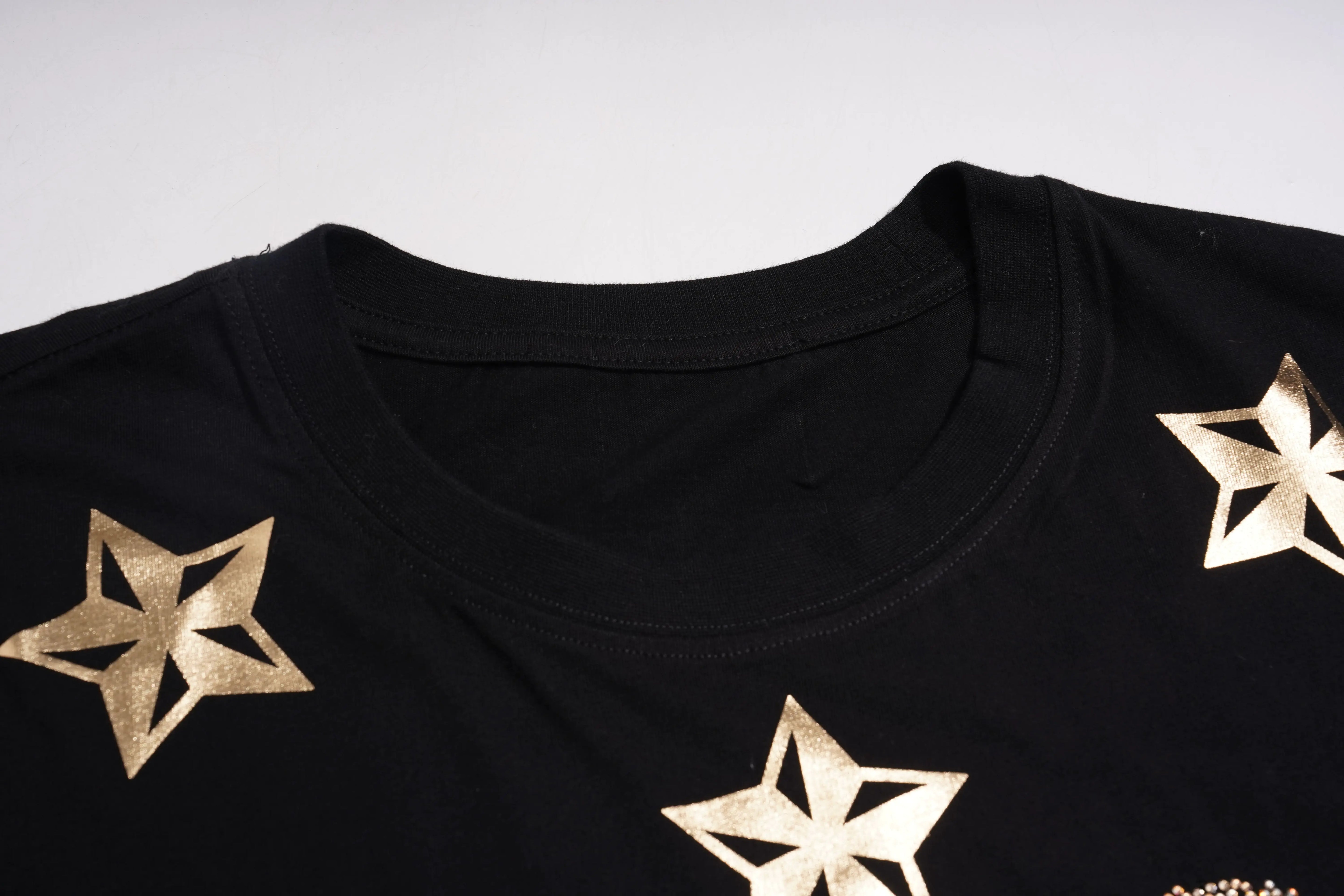 Black shirt with gold star patterns on a white background, TCH Rhinestone Teddy Bear Black T-Shirt