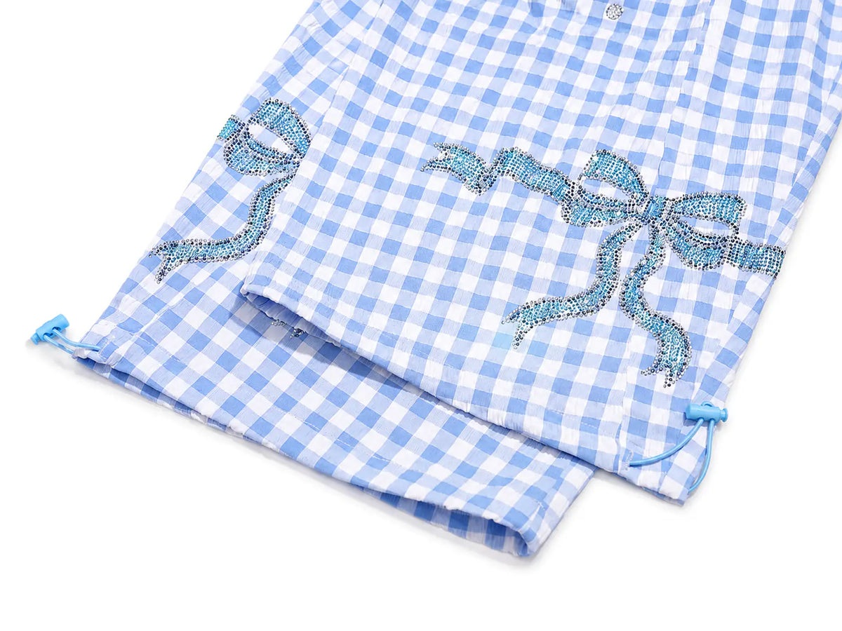 Light blue and white gingham pajama shorts with embroidered light blue bows on a white background. TCH Rhinestone Teddy Bear Bow Gingham Wide-Leg Pants