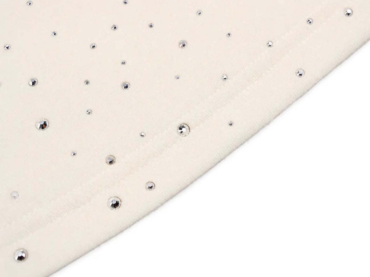 Close-up of a cream-colored fabric surface with scattered small silver rhinestones, shown against a white background. TCH Rhinestone Teddy Bear Bow Graphic Cropped T-Shirt