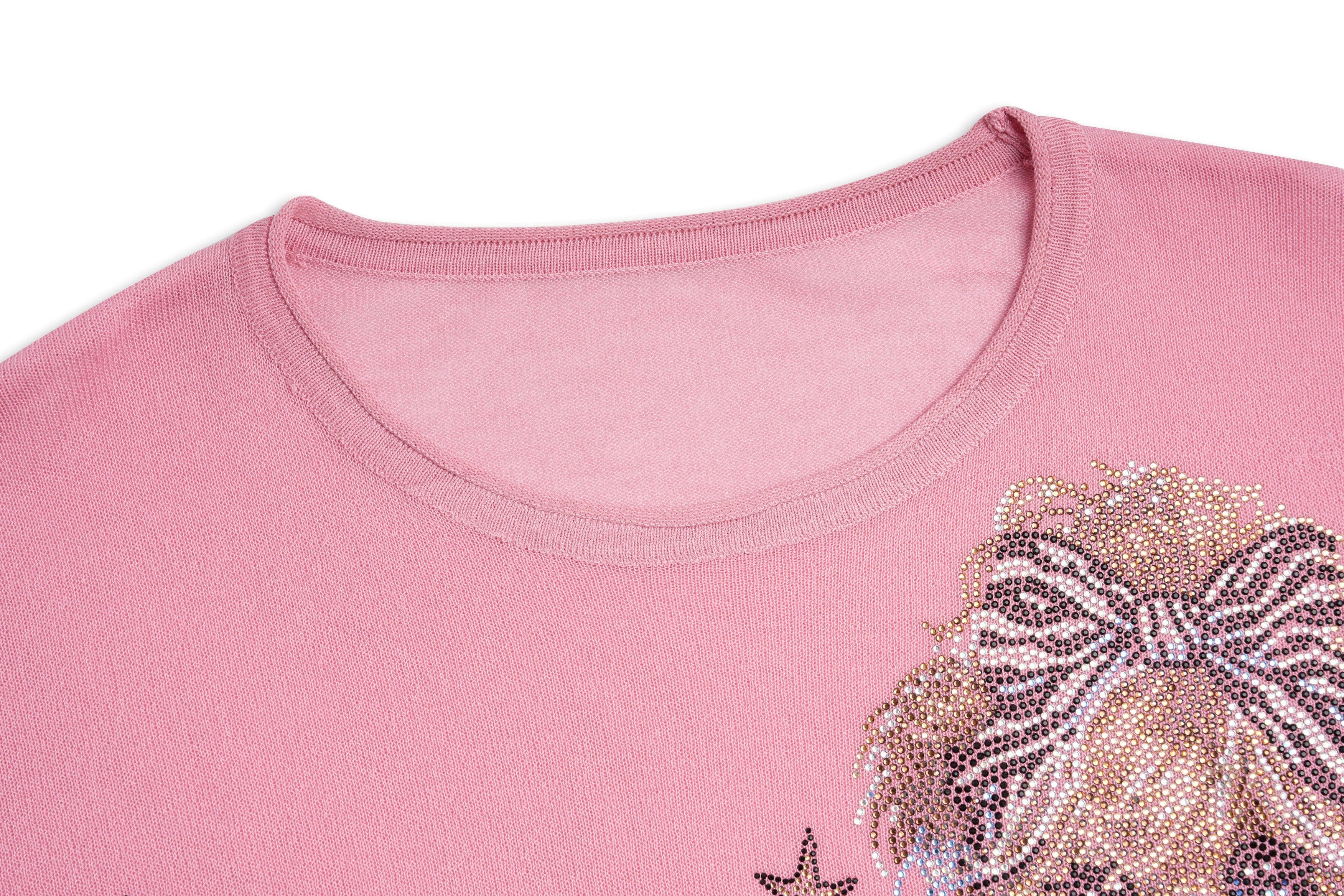 Close-up of a pink shirt with a decorative bow and star design. TCH Rhinestone Teddy Bear & Bow Pink Long Sleeve Top