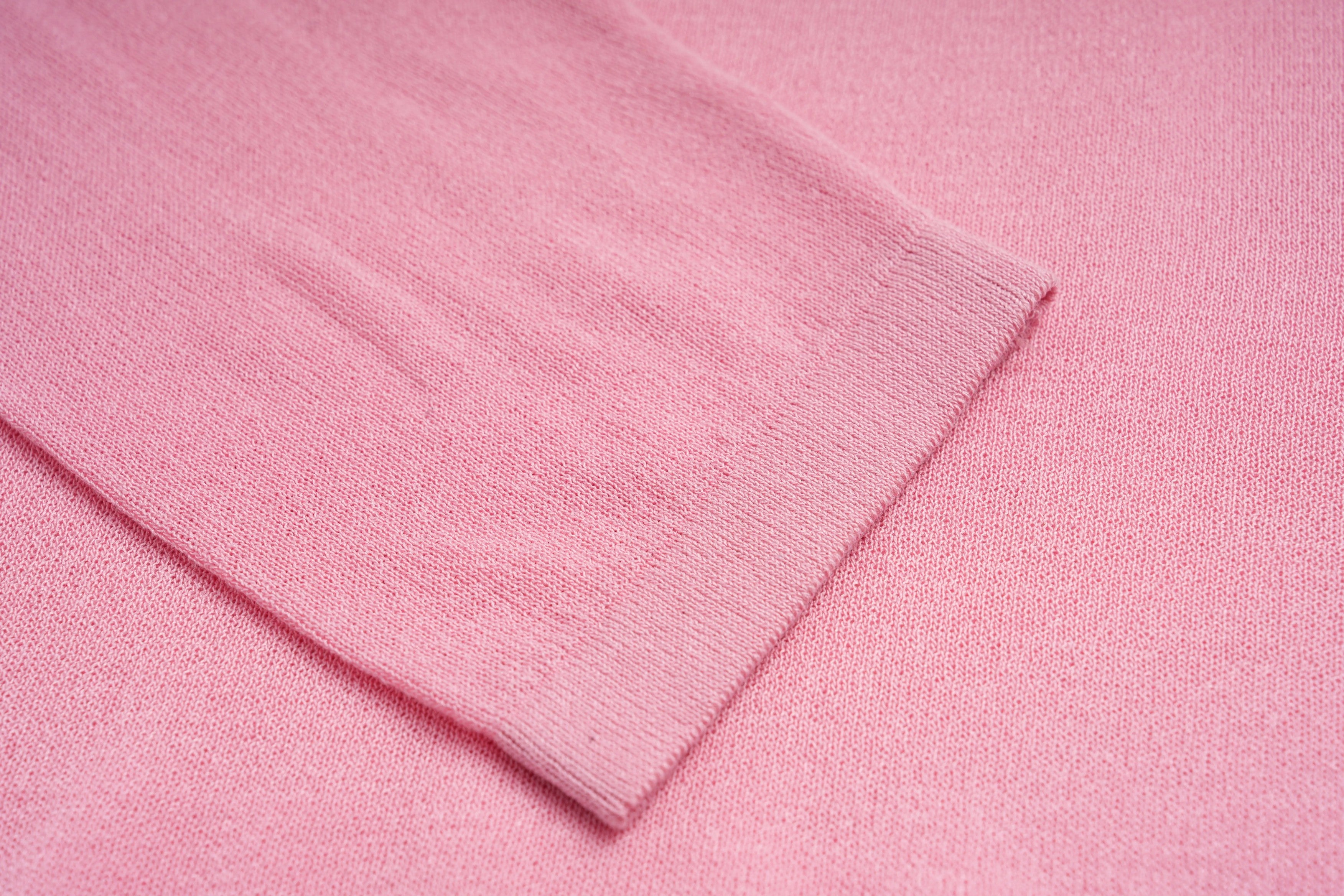 Close-up of pink fabric with a subtle texture, TCH Rhinestone Teddy Bear & Bow Pink Long Sleeve Top