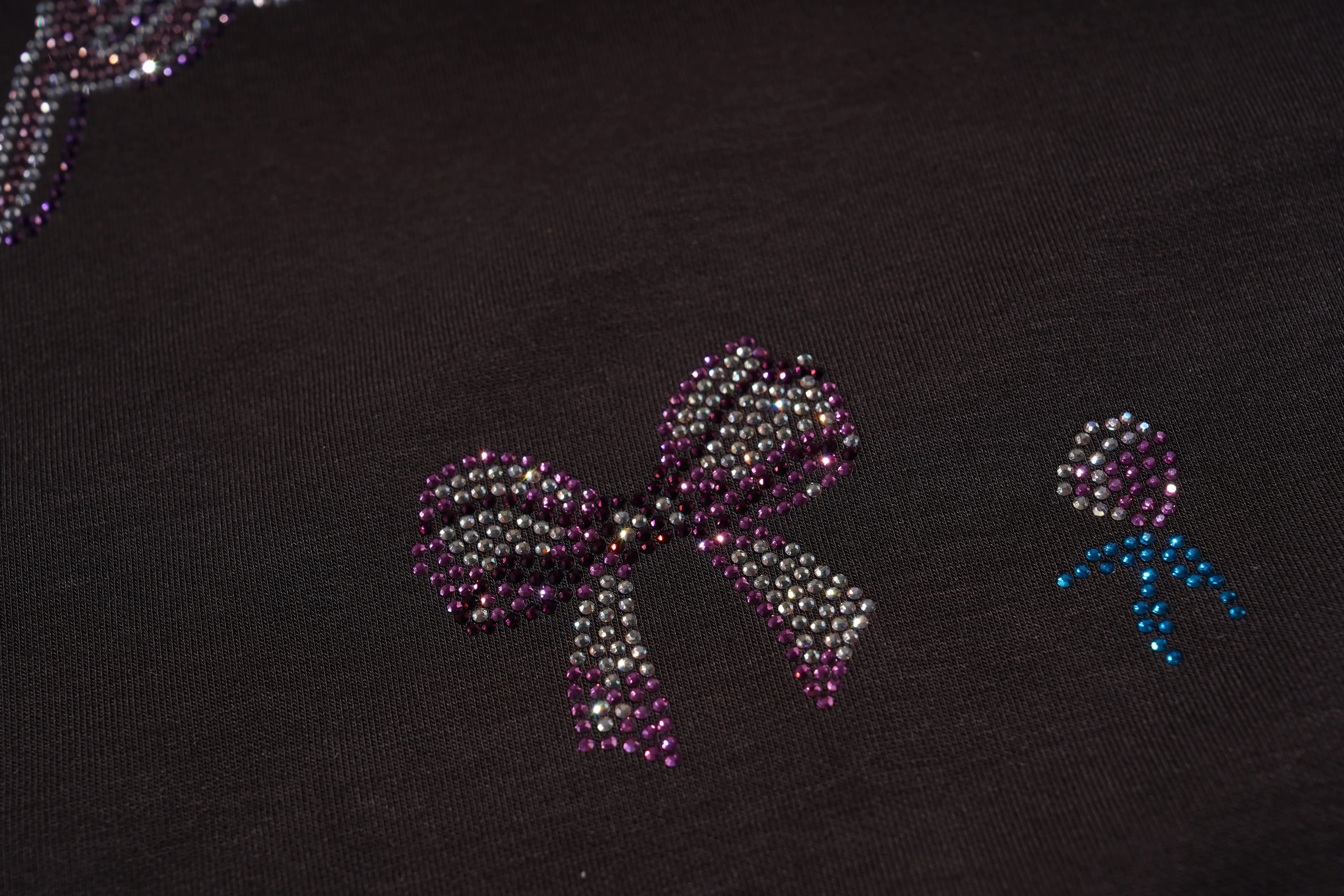 Decorative bow and flower made of rhinestones on a dark fabric background, TCH Rhinestone Teddy Bear & Bow Set