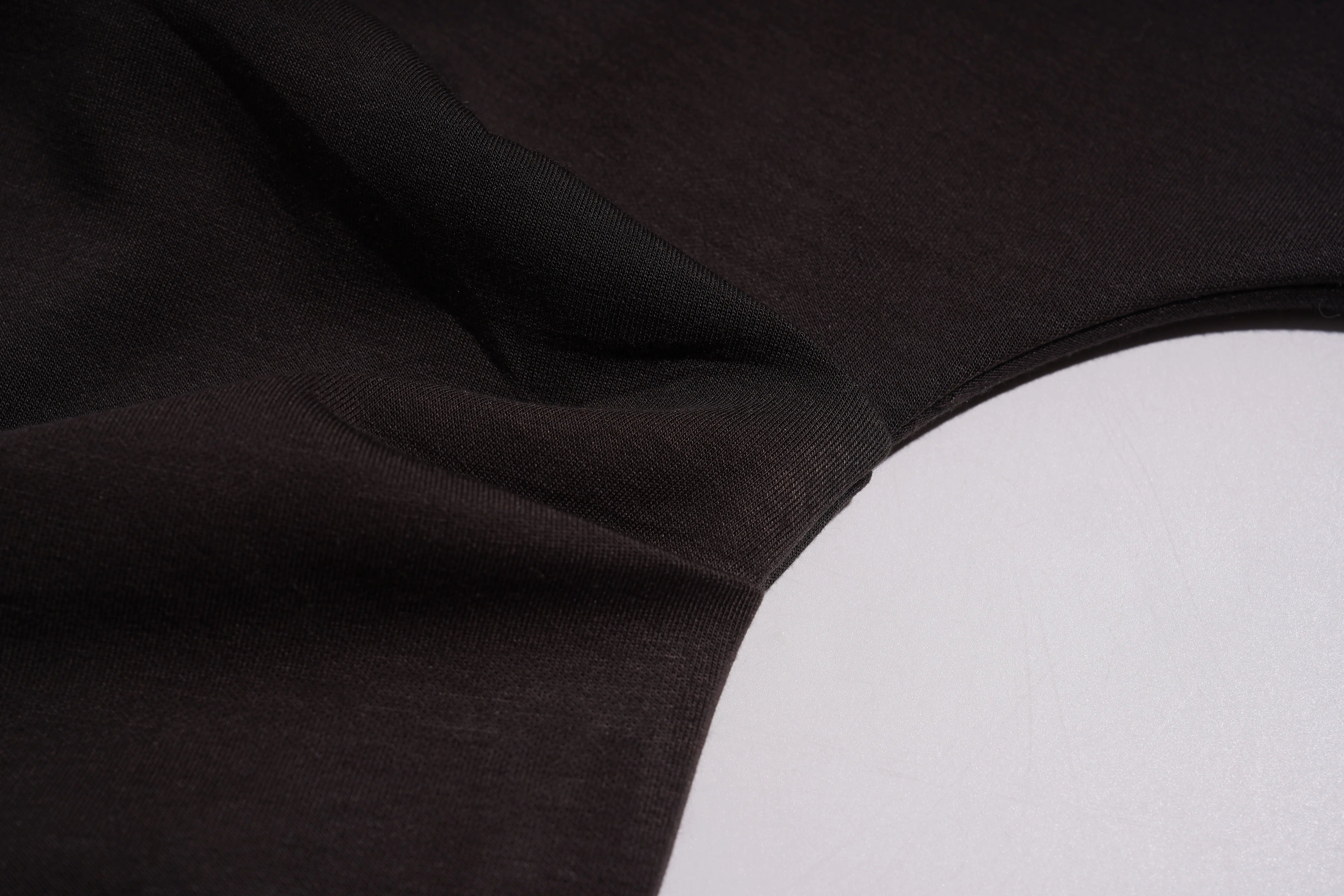 Close-up of black fabric with a white patch, TCH Rhinestone Teddy Bear & Bow Set