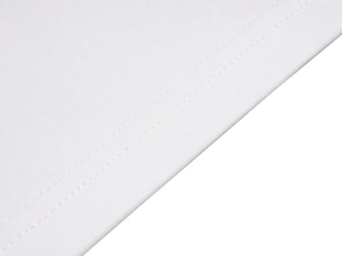A close-up of a white fabric surface with a diagonal stitched edge against a white background. TCH Rhinestone Teddy Bear Charm Graphic Long Sleeve Sweatshirt