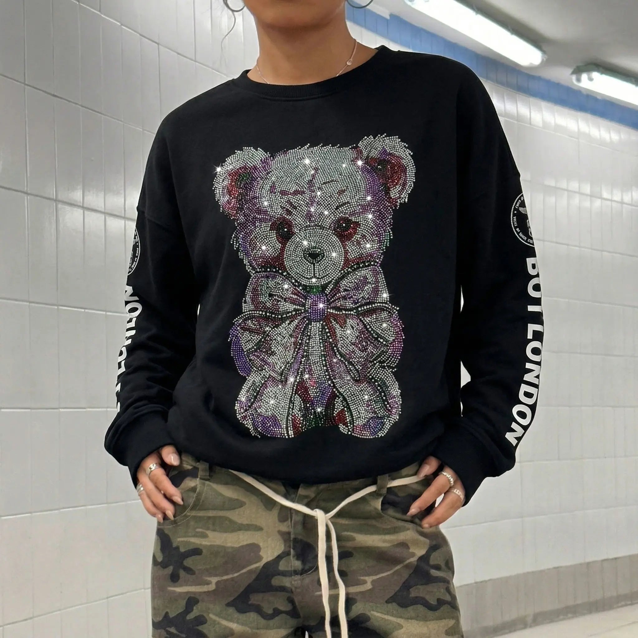 Person wearing a TCH Rhinestone Teddy Bear Graphic Crewneck Sweatshirt.