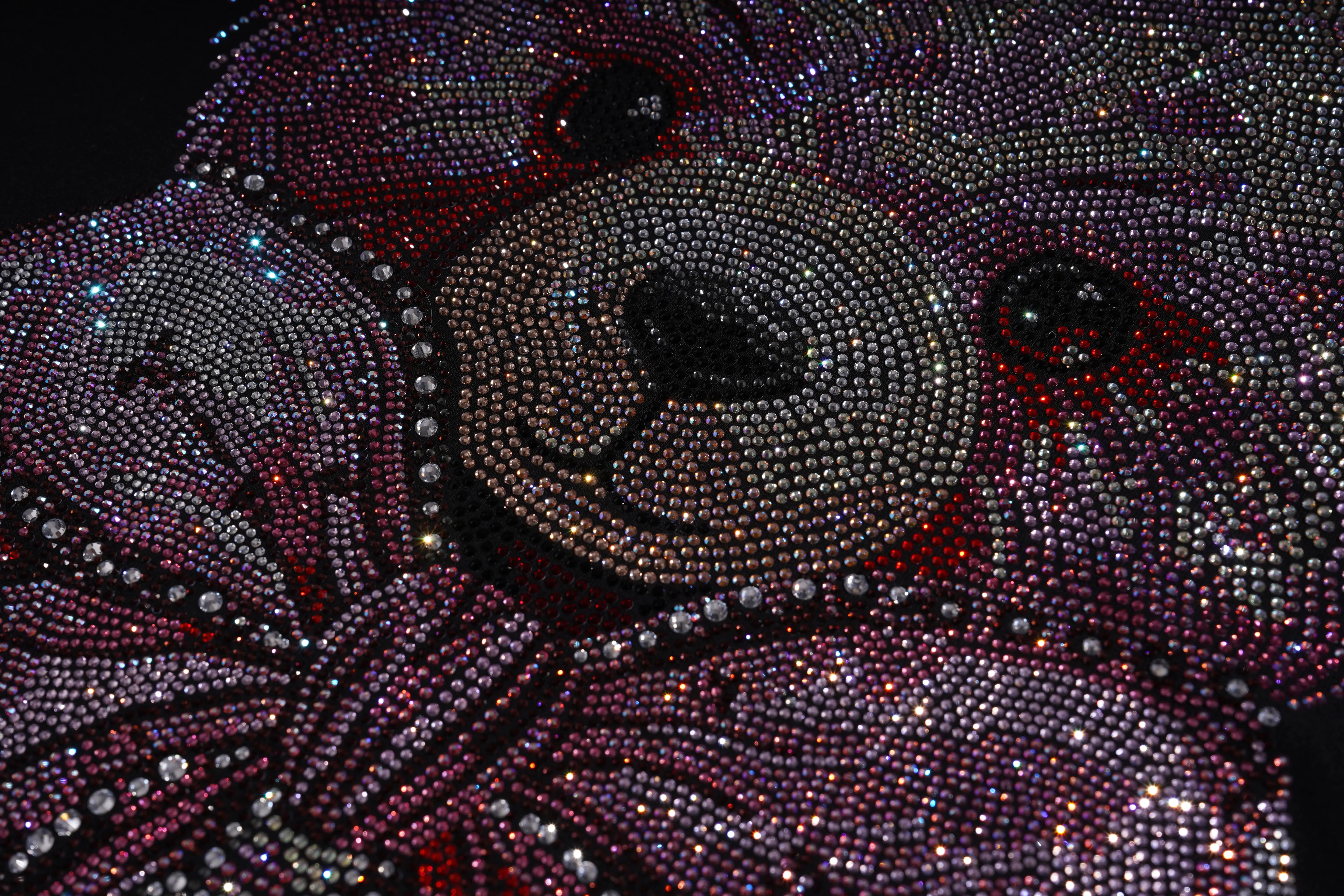 Close-up of a teddy bear made of rhinestones with a black background