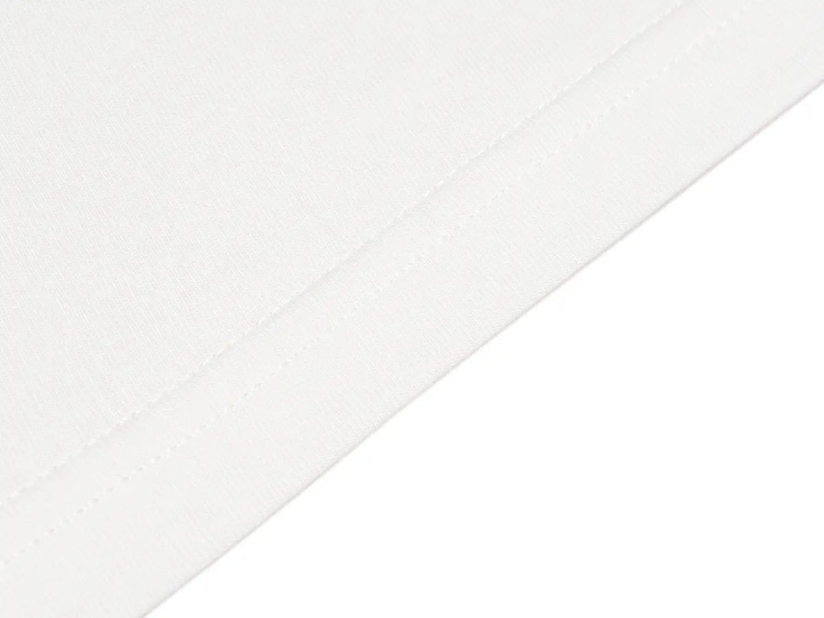 A close-up of a white fabric surface with a diagonal stitched seam, showing the material texture and color. TCH Rhinestone Teddy Bear Graphic Striped Sleeve Long Sleeve Top