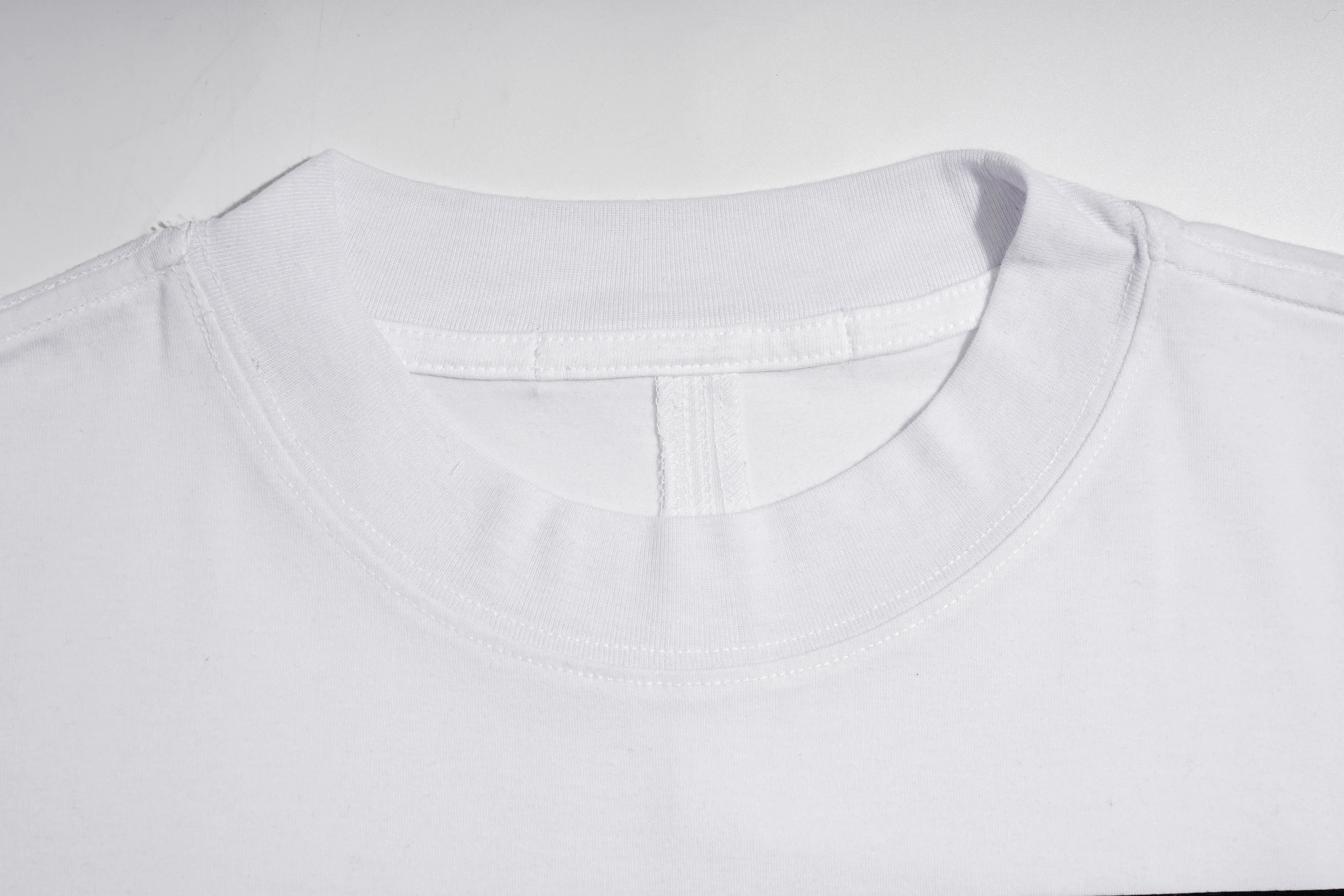 Close-up of a white crew-neck t-shirt showing the inner collar construction and stitching details against a plain white background. TCH Rhinestone Teddy Bear Graphic White T-Shirt