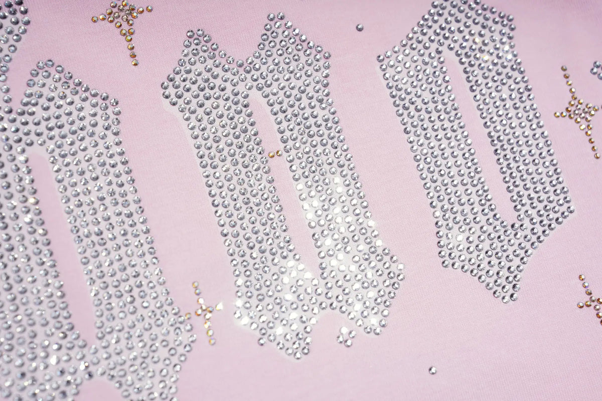 Silver rhinestone lettering spelling 'JUNIOR' arranged on a light pink background, with small gold decorative accents. TCH Rhinestone Teddy Bear Pink Long Sleeve T-Shirt