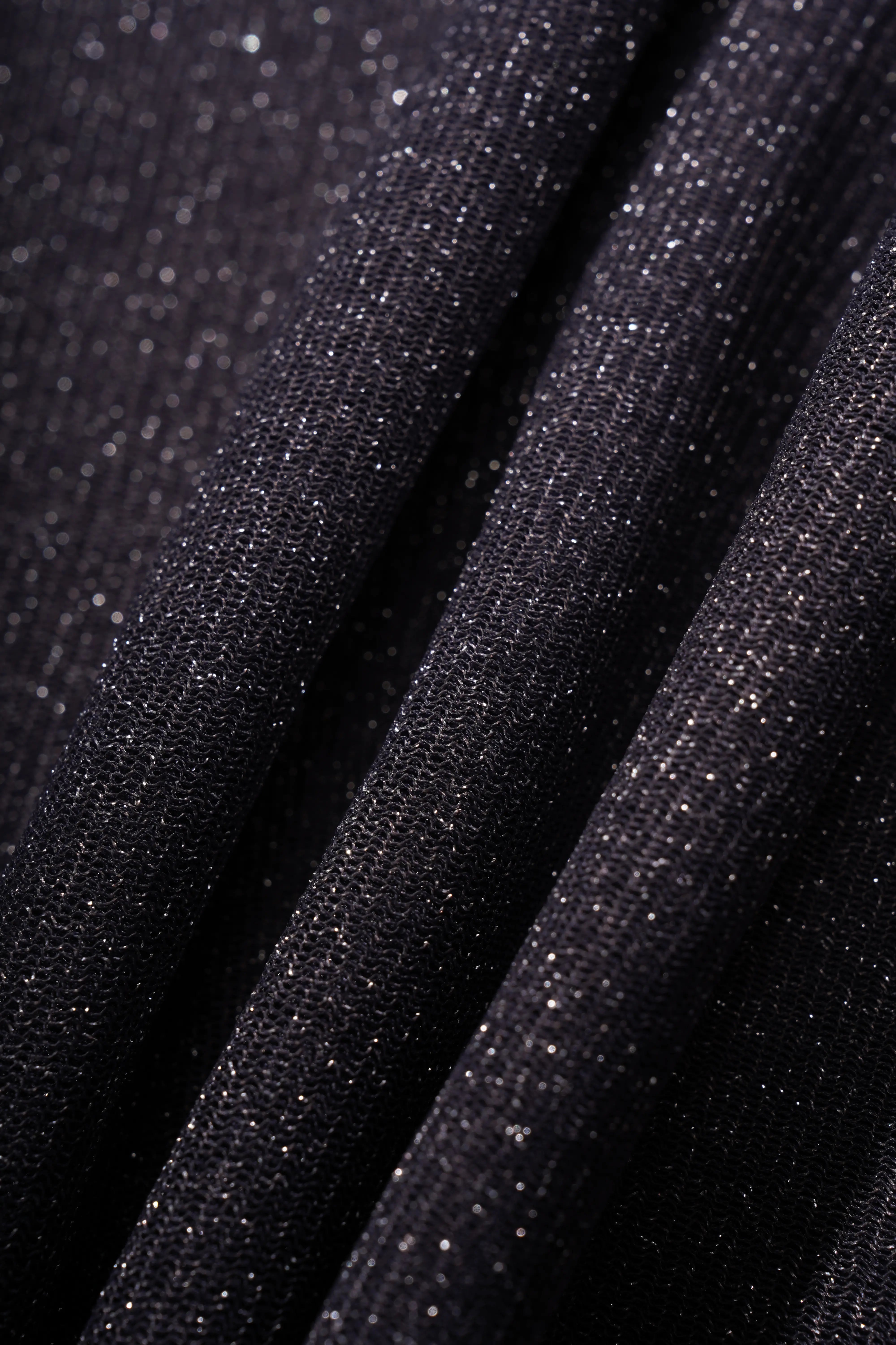 A close-up of dark charcoal gray fabric with a fine glitter texture, draped in soft folds. TCH Rhinestone Teddy Bear Sheer Mesh Long Sleeve Top
