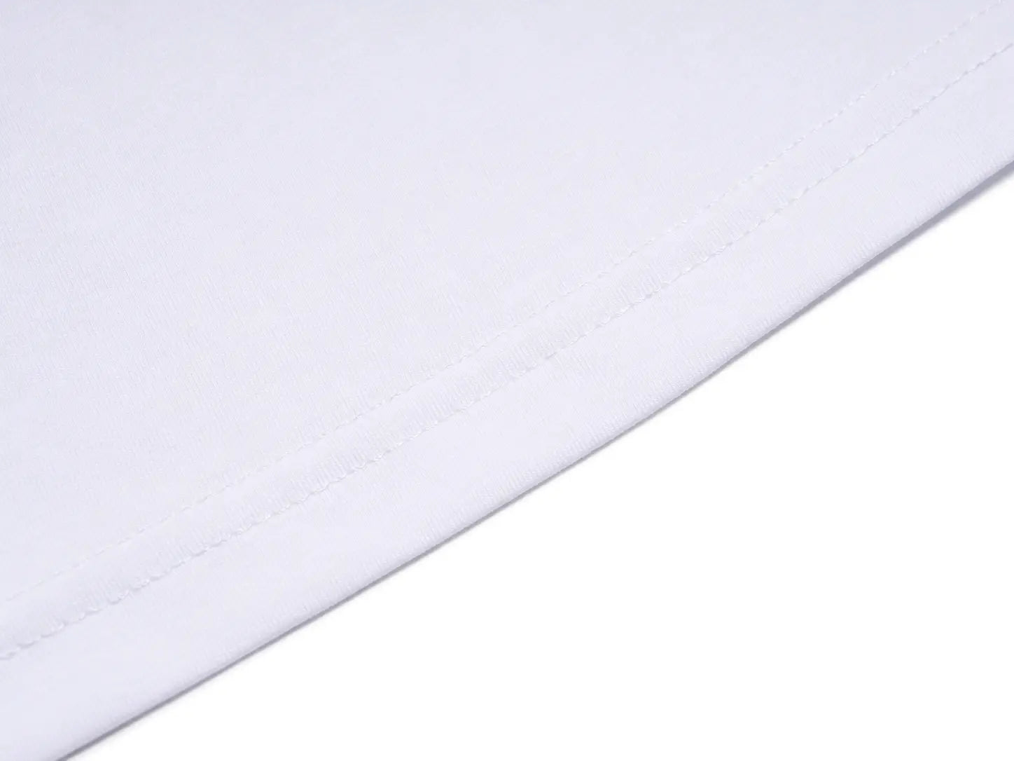 A close-up of a white fabric surface with a visible stitched edge against a white background. TCH Rhinestone Teddy Bear Tie Graphic White T-Shirt