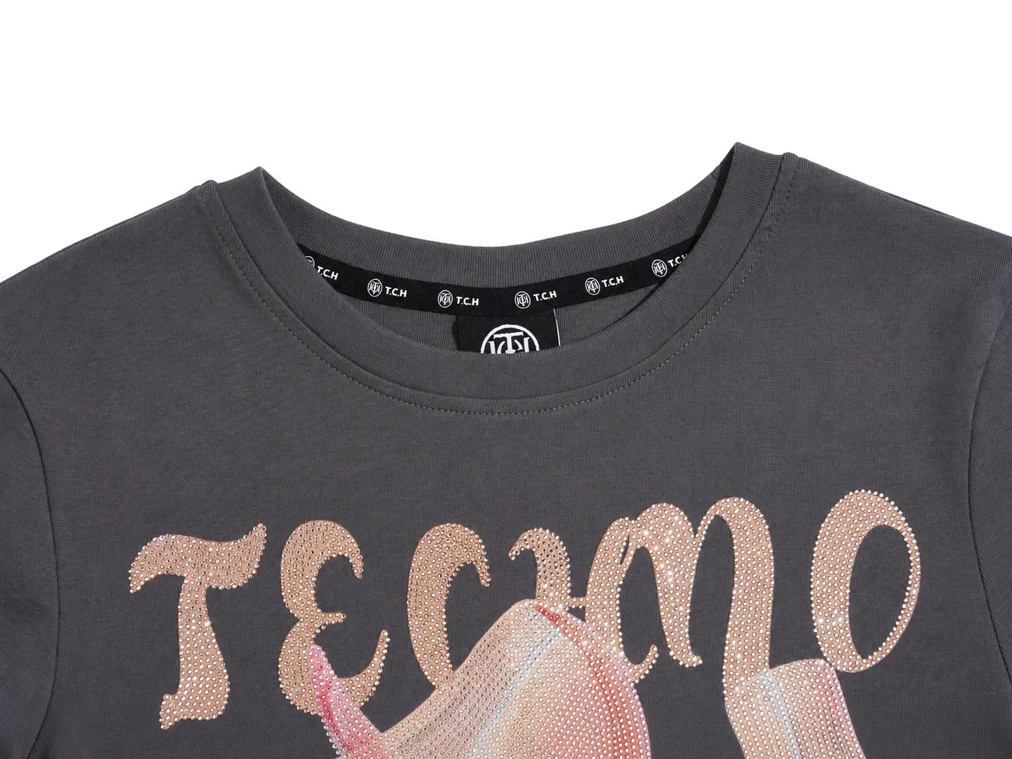 Close-up of a dark gray crewneck T-shirt with a sparkling rose gold 'TECMO' graphic across the chest and a pink graphic below, on a white background. TCH Rhinestone Unicorn Graphic Charcoal T-Shirt