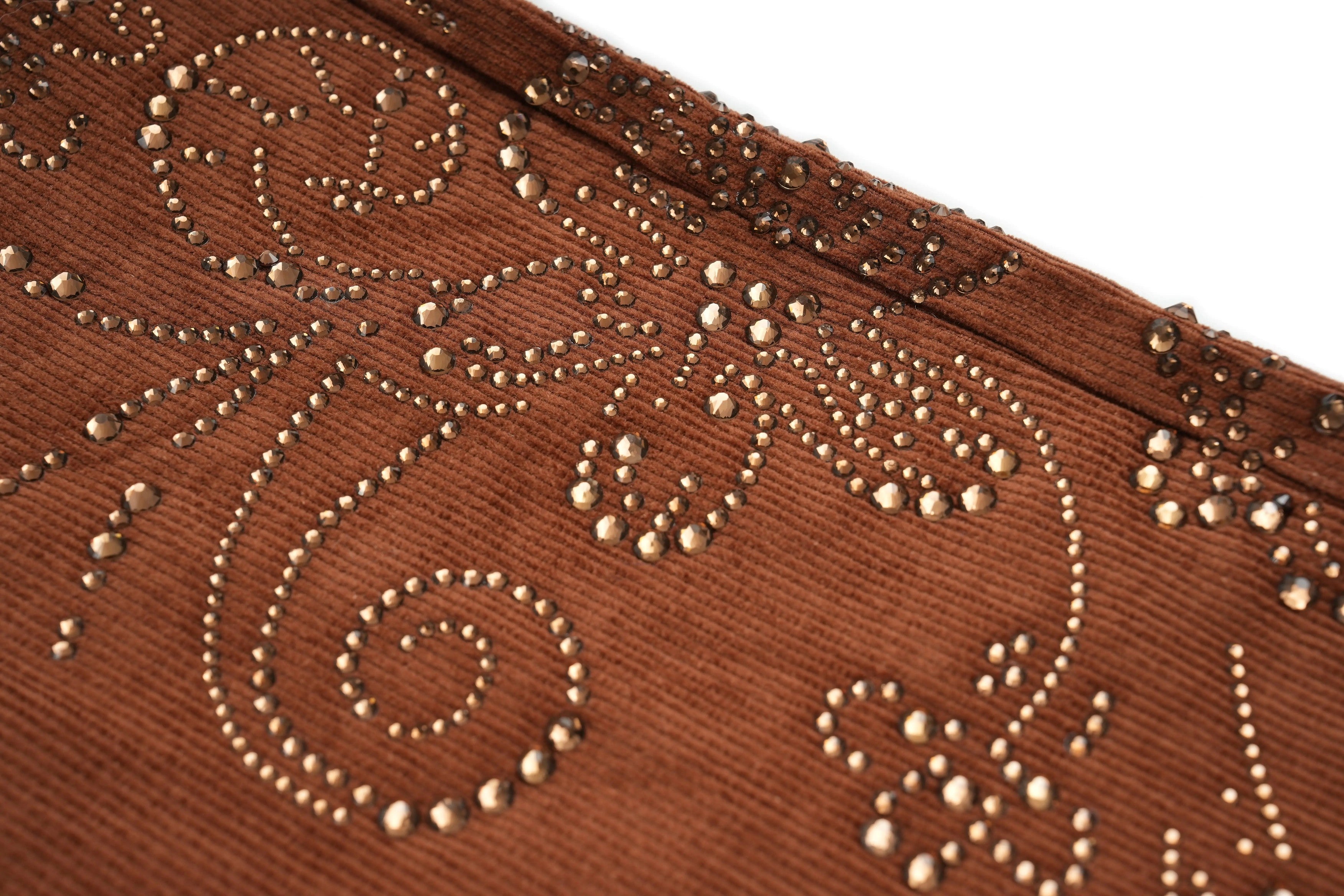 Close-up of a brown fabric with intricate gold beadwork, TCH Rhinestone Vine Brown Denim Jeans