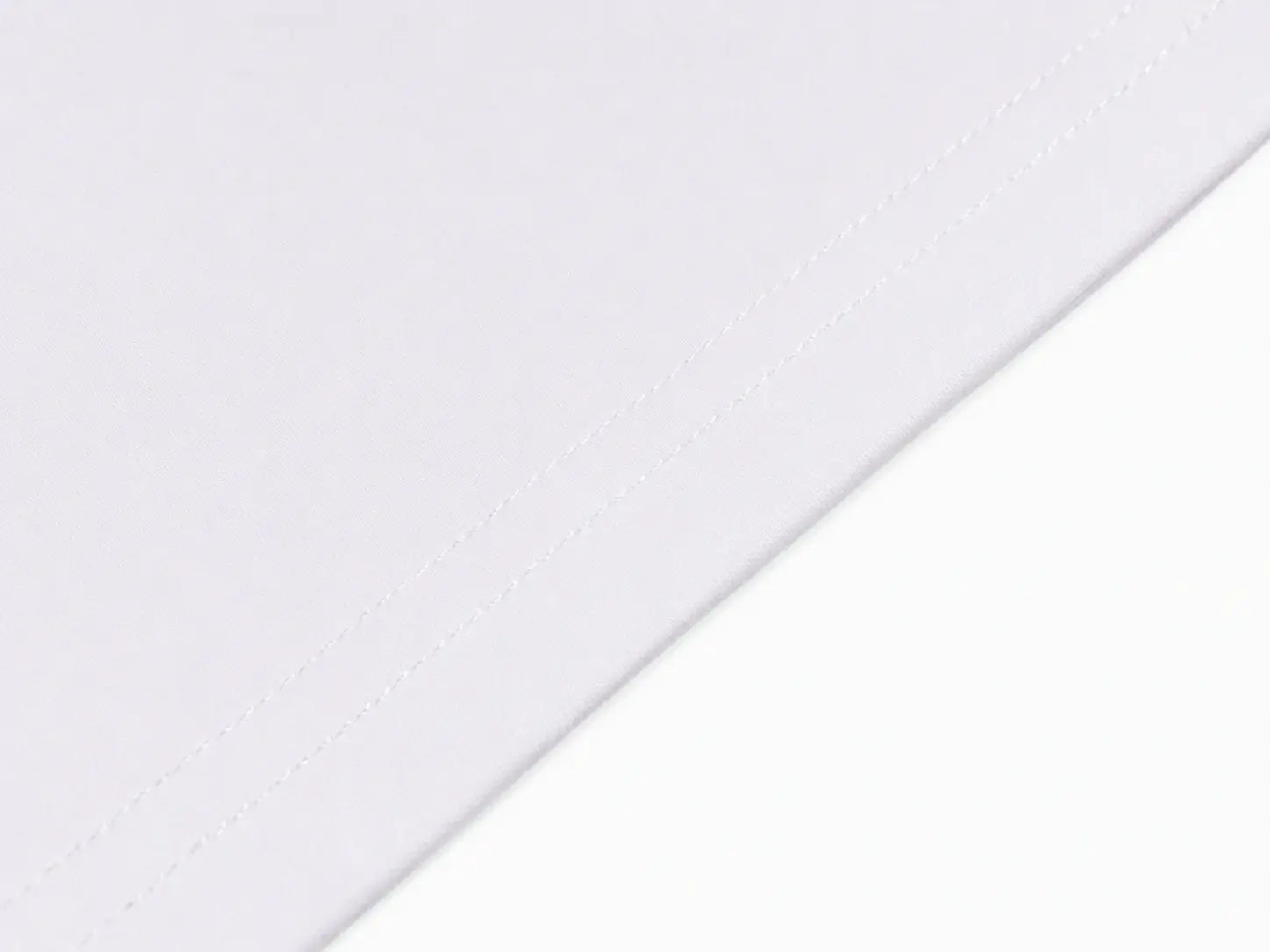 A close-up of a white fabric surface with a diagonal stitched seam and a clean white background. TCH Rhinestone Vintage Bow Graphic White T-Shirt