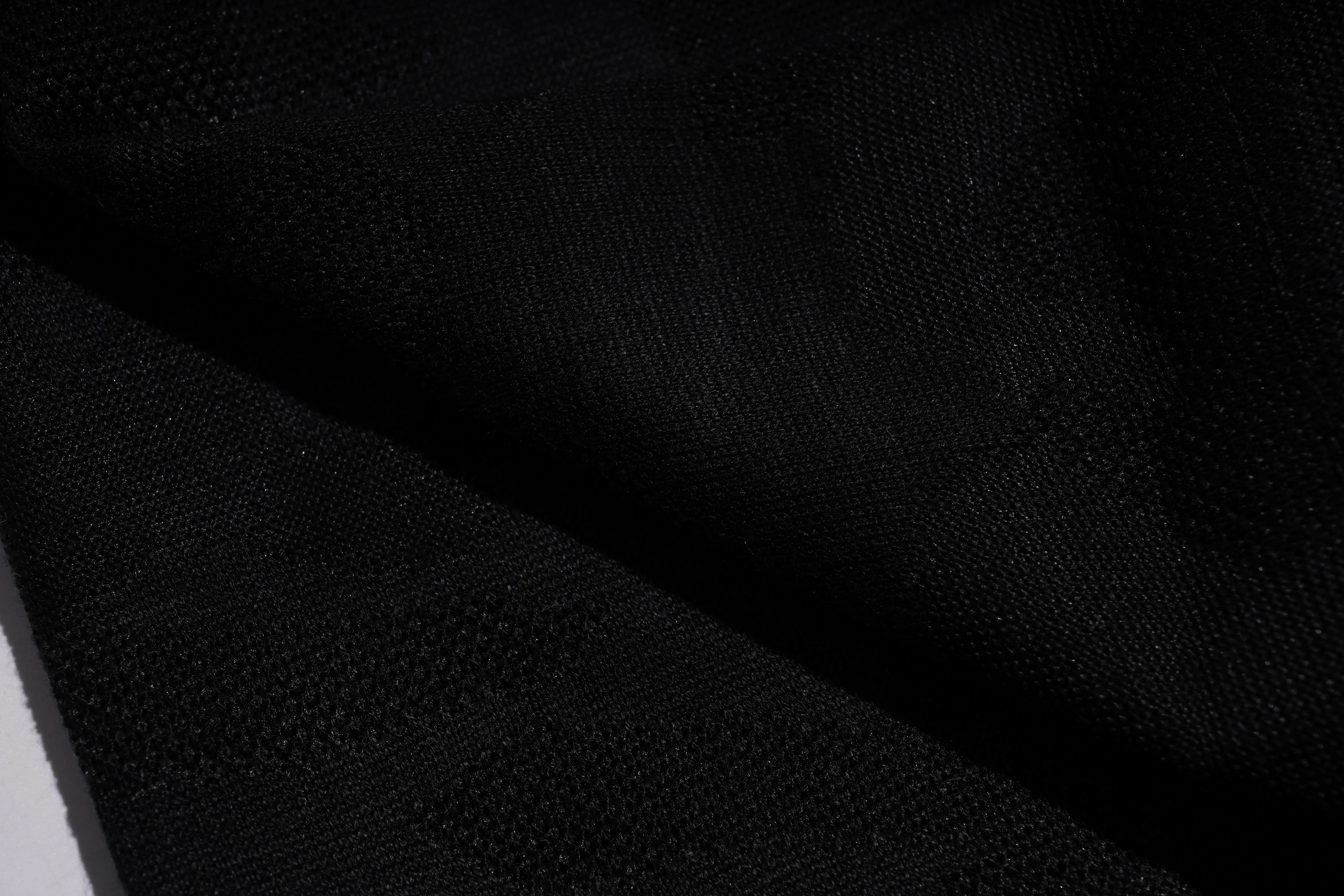 Close-up of black fabric texture, TCH Rhinestone Wing Camo Jogger Pants