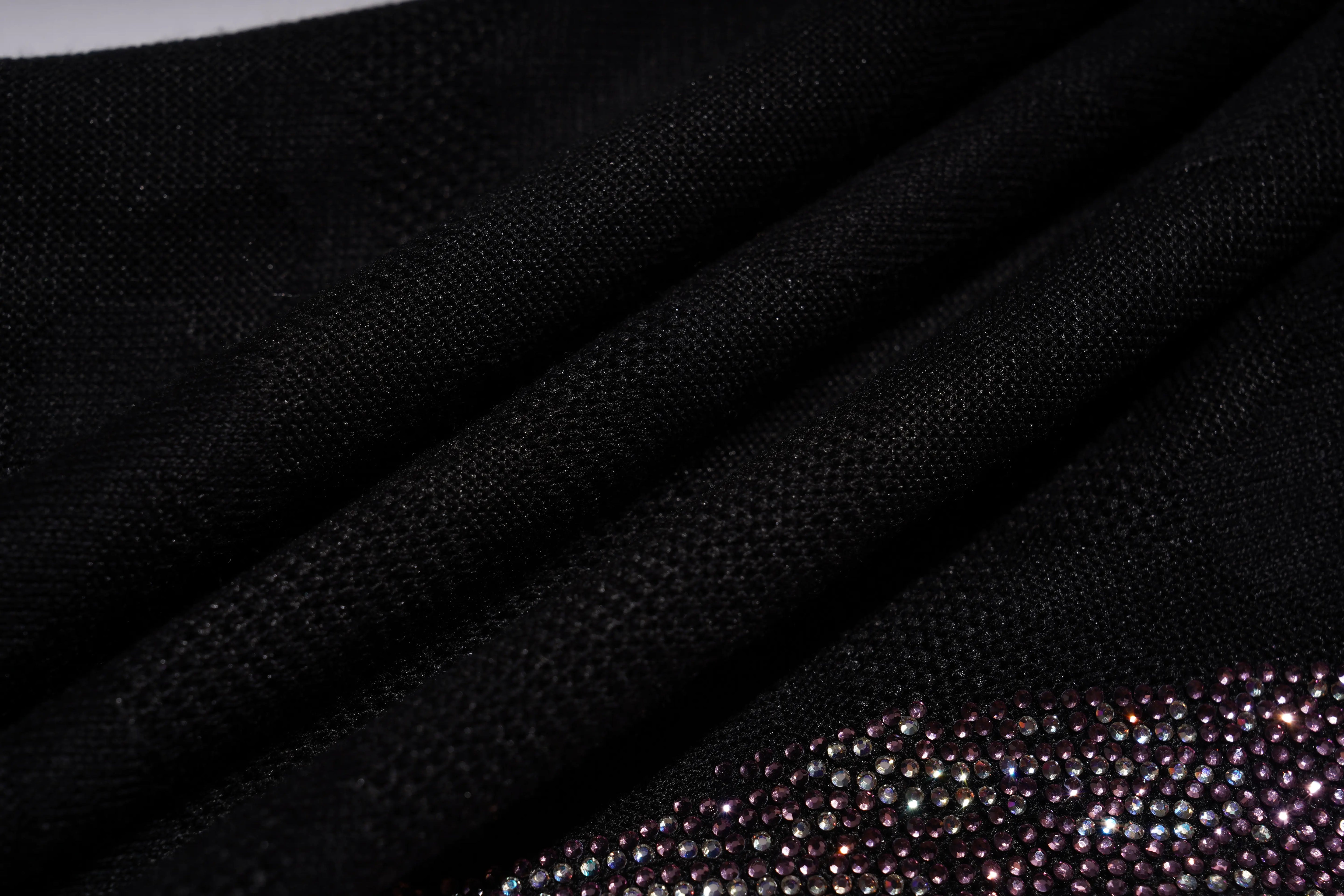 Close-up of black fabric with a textured pattern, TCH Rhinestone Wing Camo Jogger Pants