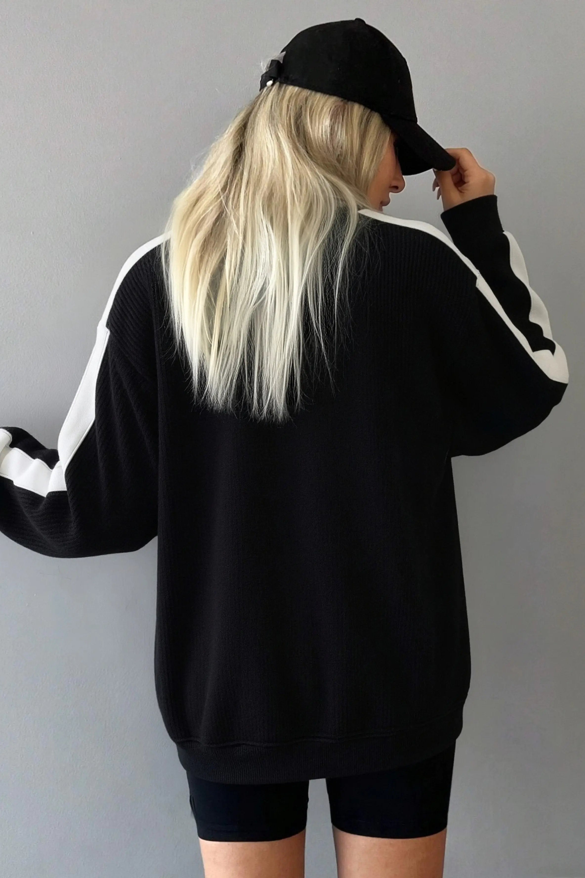 Person wearing a black and white tracksuit with a plain background， TCH Rhinestone Wing M Embroidered Sweatshirt