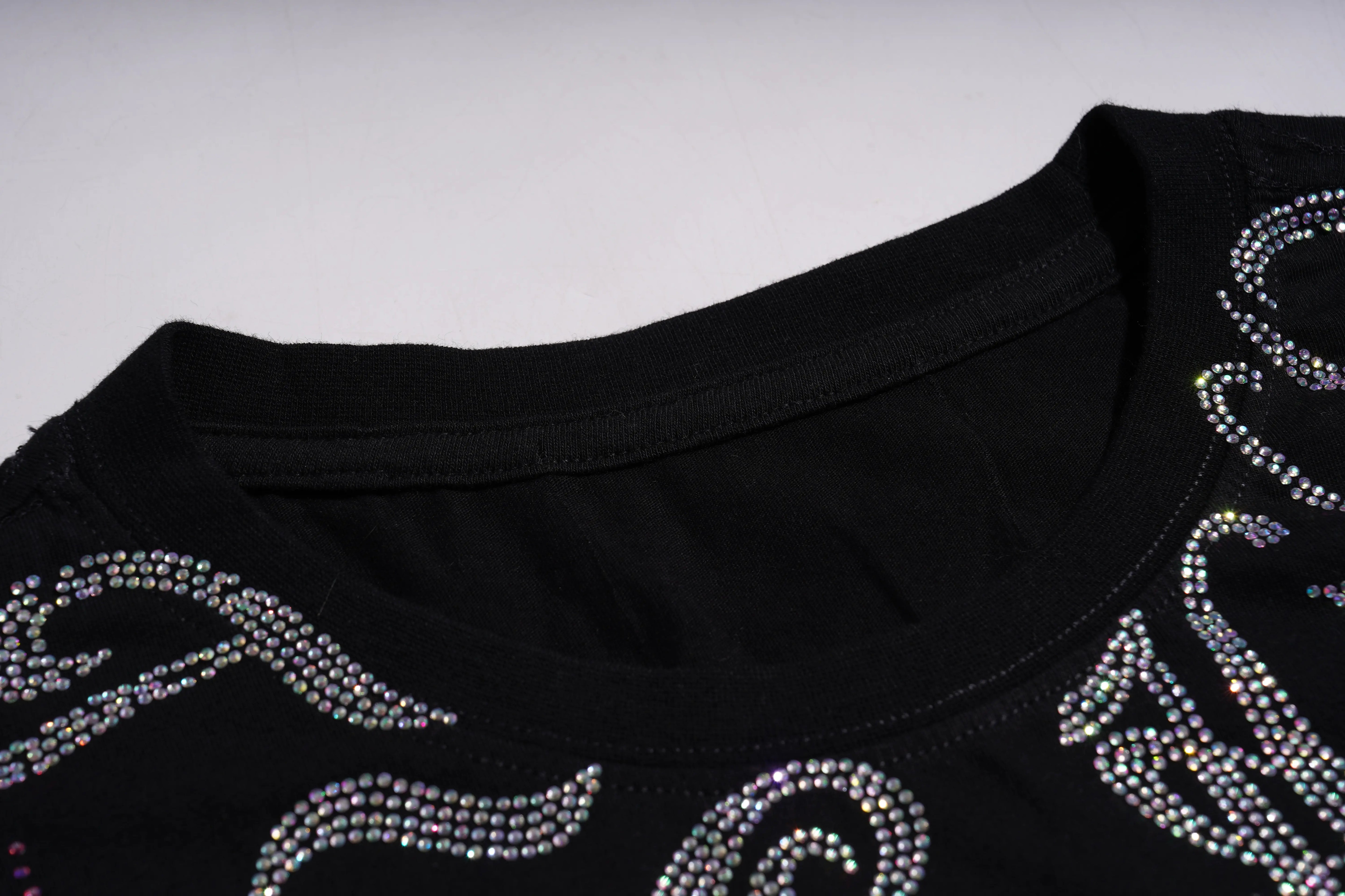 Black garment with decorative rhinestone patterns on a plain background, TCH Rhinestone Winged Unicorn T-Shirt