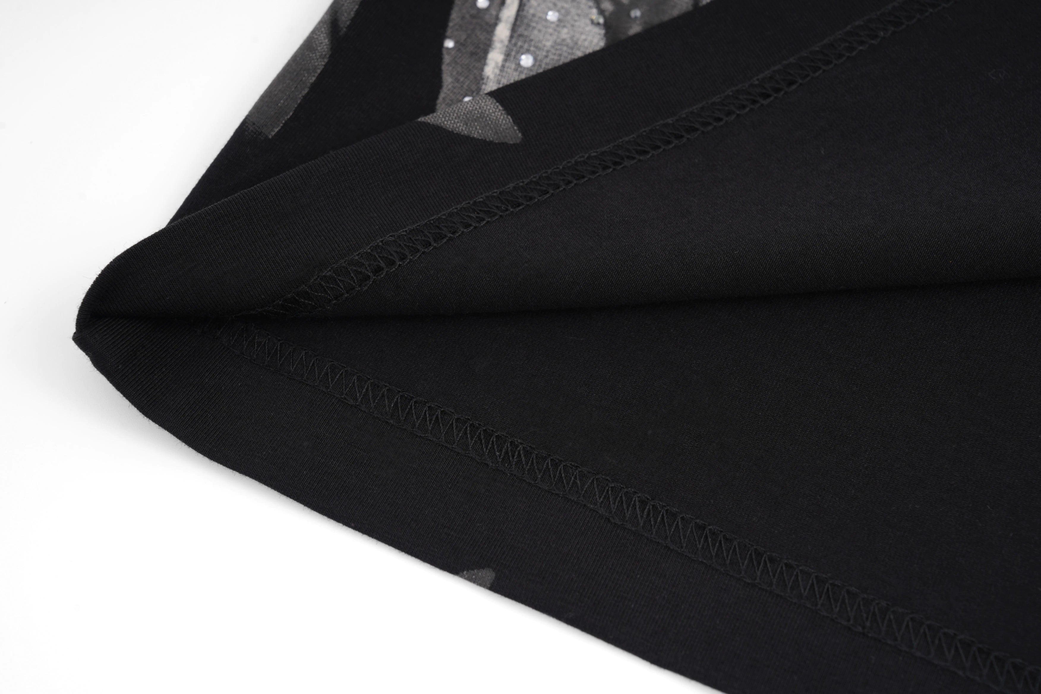 Close-up of black fabric with a white background, TCH Rhinestone Wings Logo Black Graphic T-Shirt