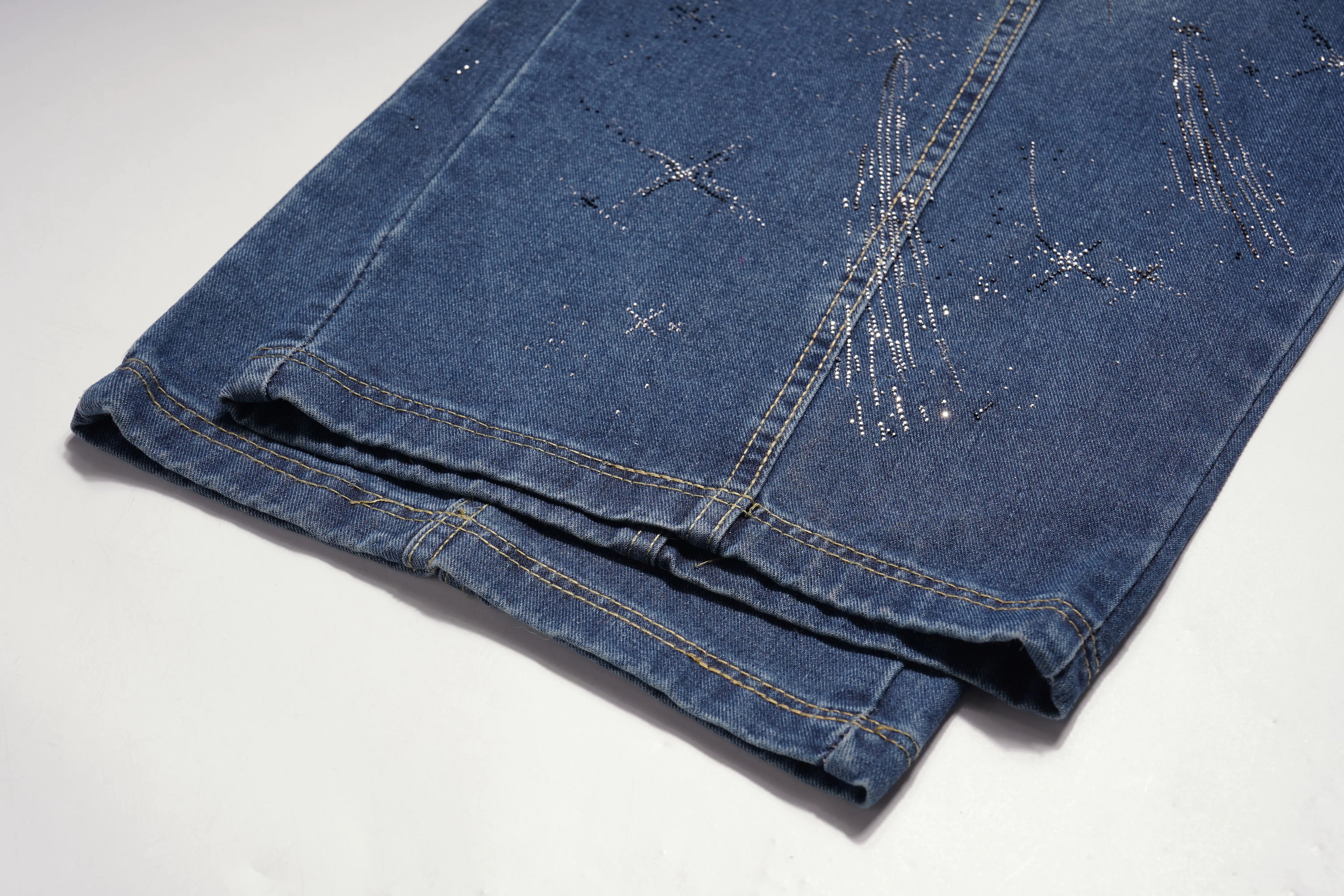 Folded blue denim jeans with star pattern on a white background, TCH Shooting Star Rhinestone Wide-Leg Blue Jeans
