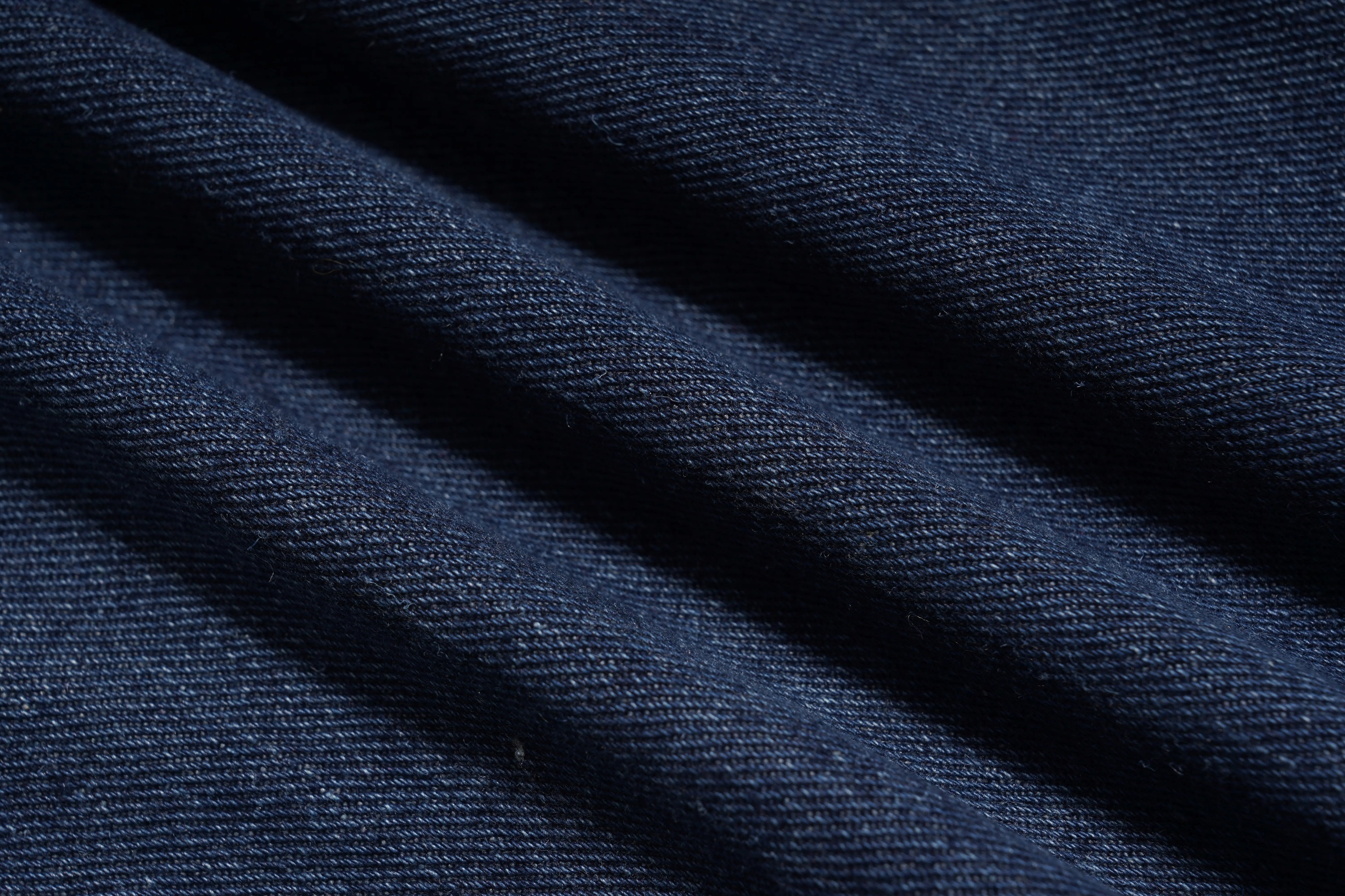 Close-up of dark blue fabric with visible texture, TCH Shooting Star Rhinestone Wide-Leg Blue Jeans