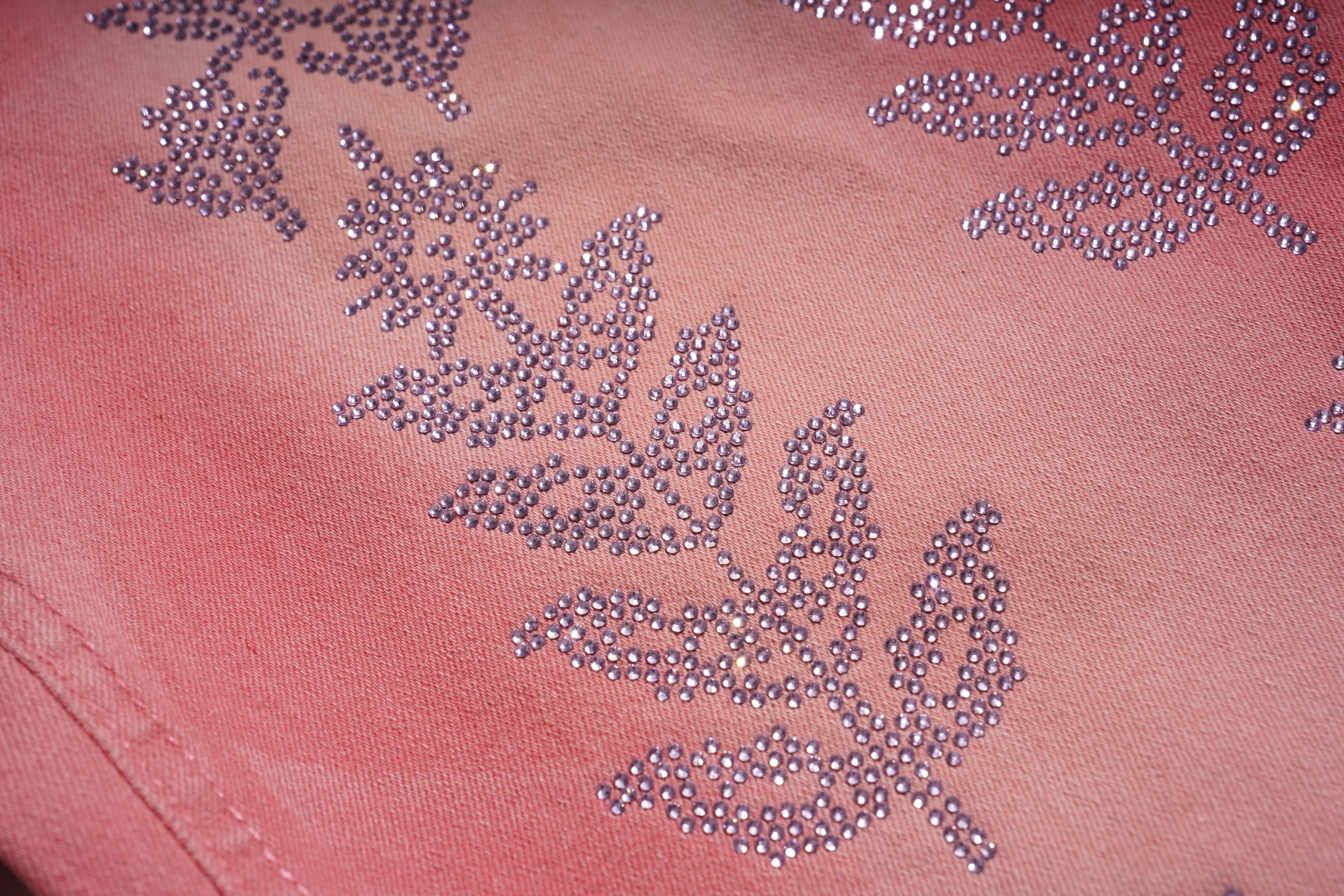 Close-up of pink fabric with floral bead embroidery, TCH Silver Bouquet Rhinestone Pink Denim Jeans