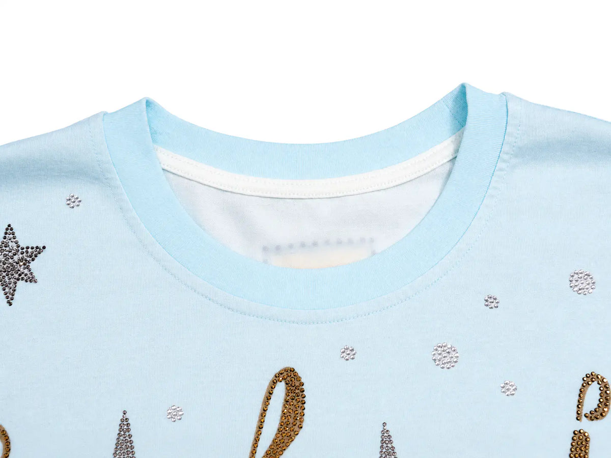Close-up of a light blue crewneck sweatshirt featuring textured rhinestone star and circle motifs, with a white inner collar lining. TCH Small Bear Angel Wings Rhinestone Graphic White Long Sleeve T-Shirt