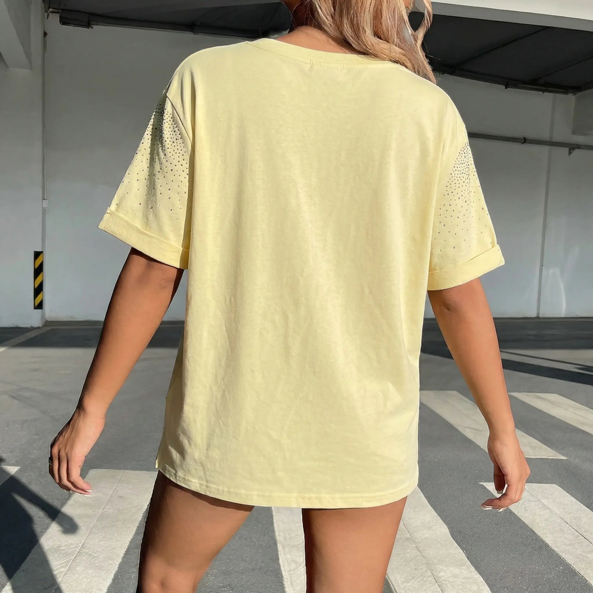 Person wearing a light yellow t-shirt with mesh details on the back, walking outdoors. TCH Starry Gradient Rhinestone Butterfly T-Shirt