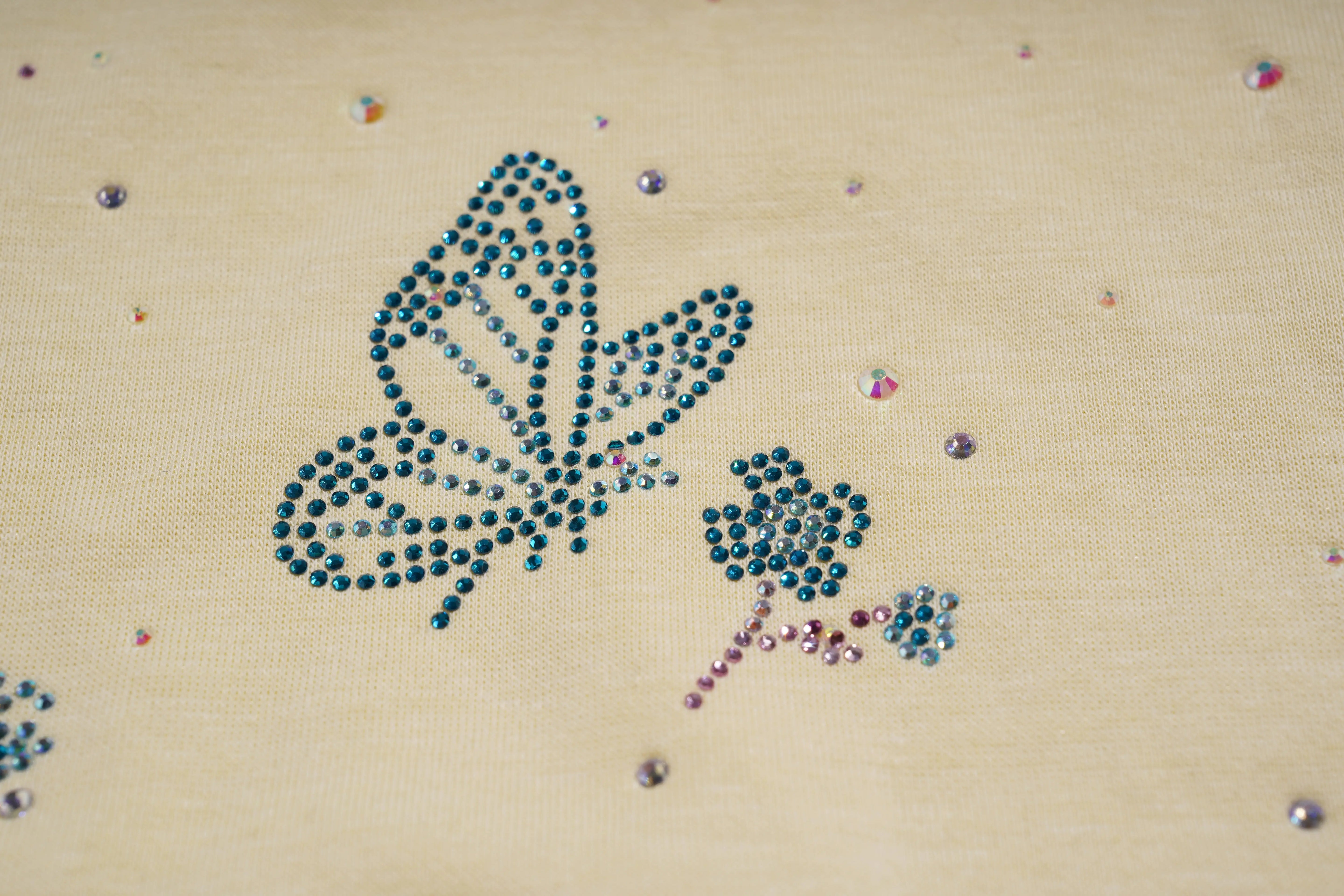Butterfly design made with rhinestones on a beige fabric background, TCH Starry Gradient Rhinestone Butterfly T-Shirt