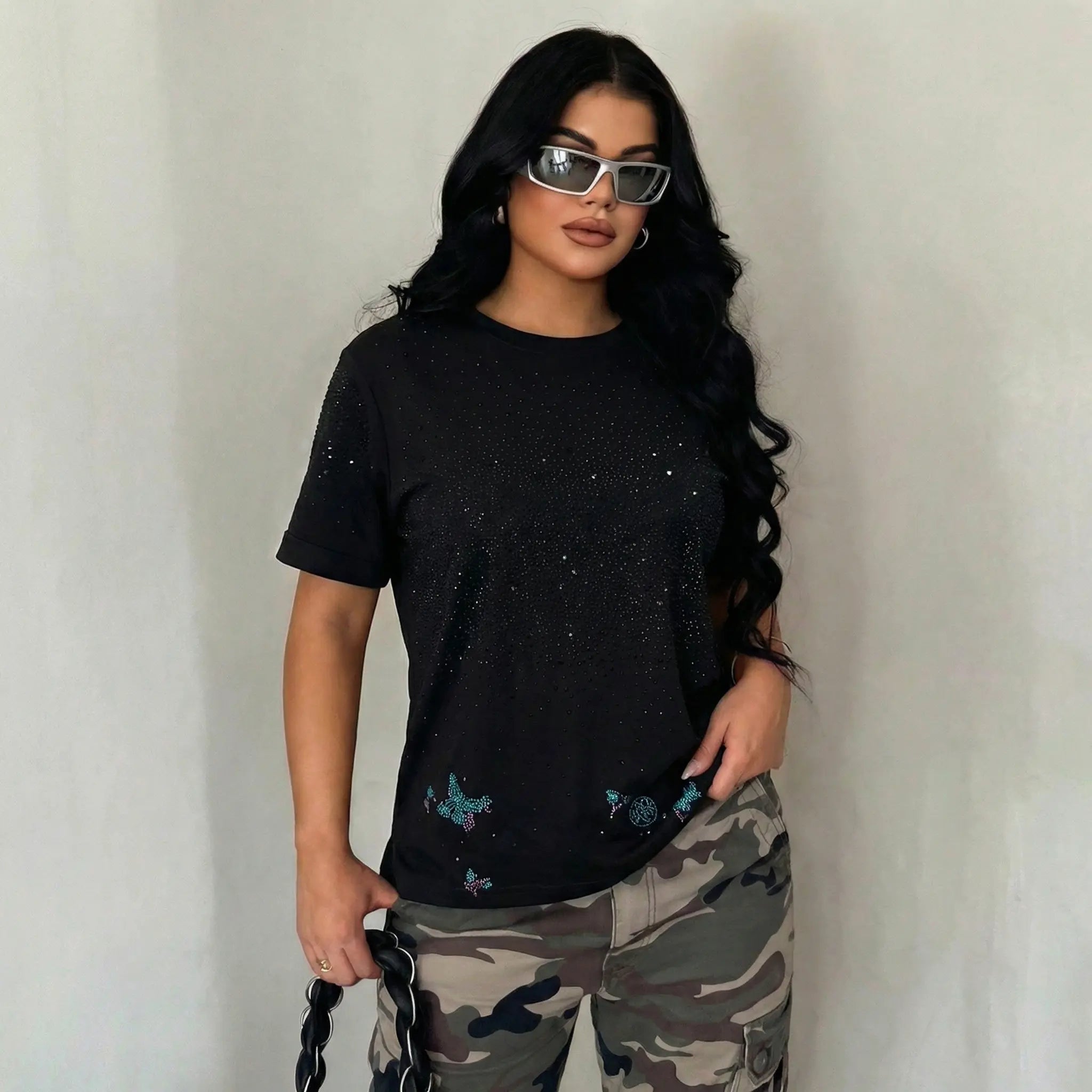 Woman wearing a black t-shirt with butterfly designs and camouflage pants against a plain background, TCH Starry Gradient Rhinestone Butterfly T-Shirt