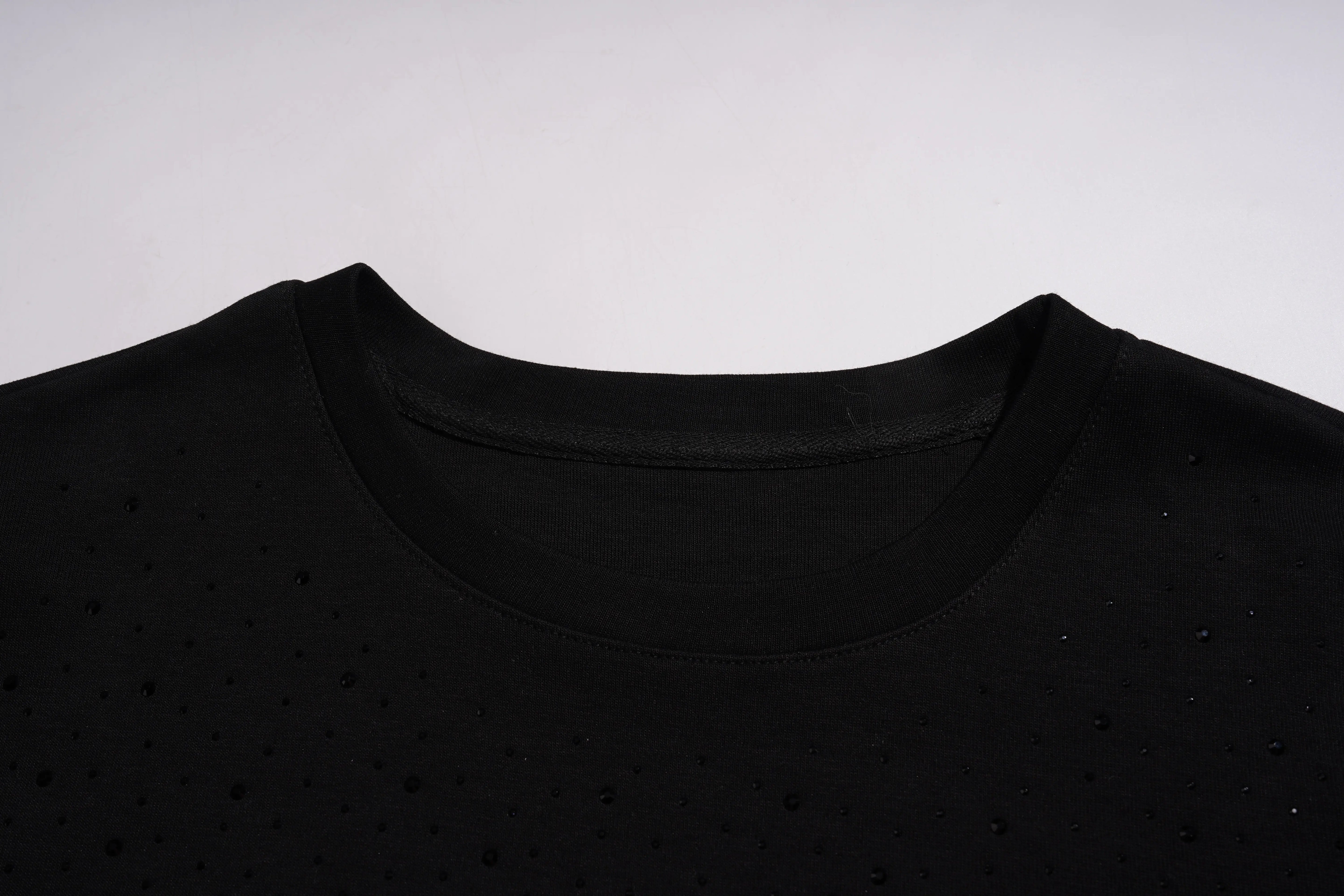 Close-up of a black shirt collar on a light gray background, TCH Starry Gradient Rhinestone Butterfly T-Shirt