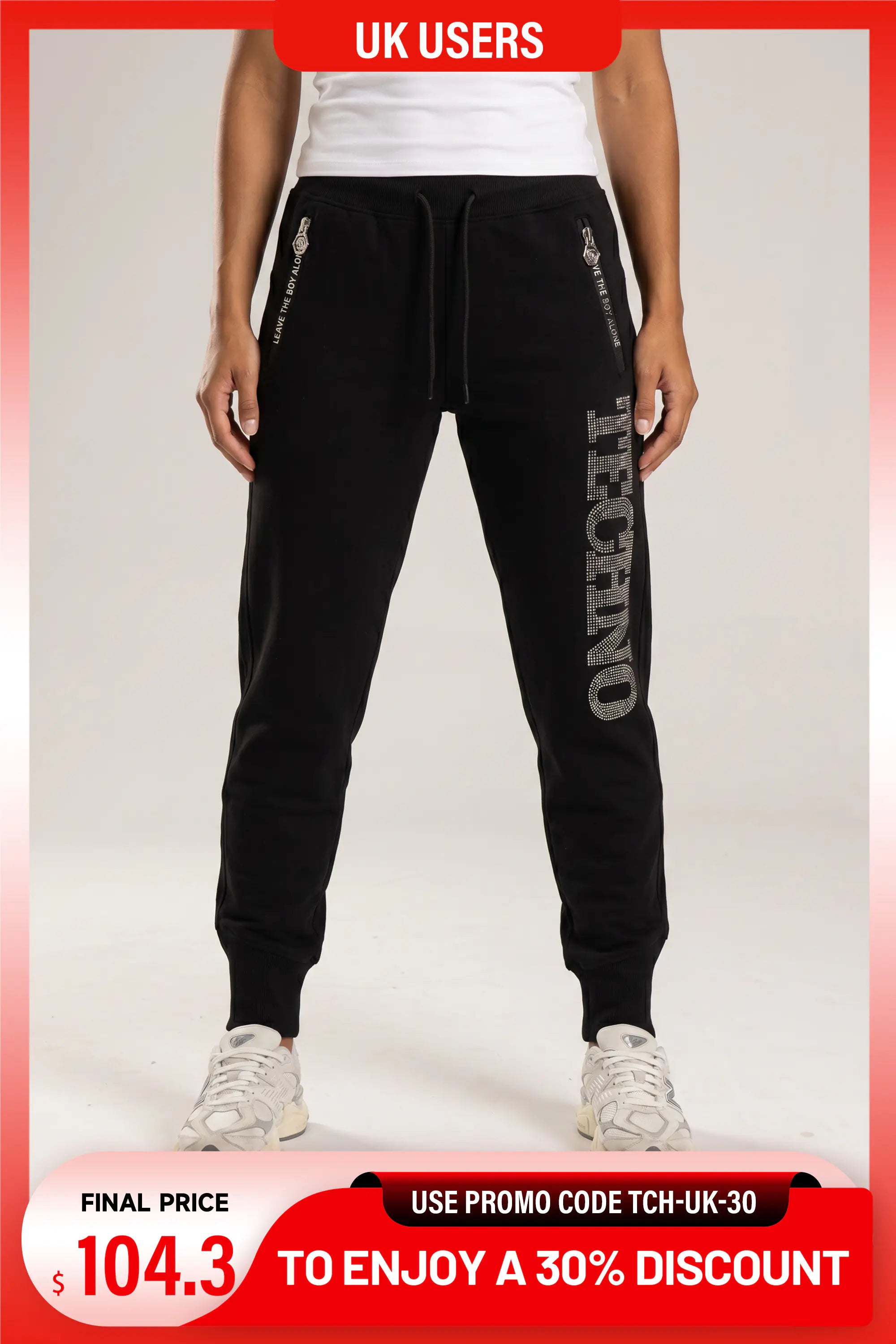 Black jogger sweatpants with white graphic text and zipper details, modeled on a person against a light gray background with promotional overlays. TCH TECHNO Rhinestone Jogger Pants