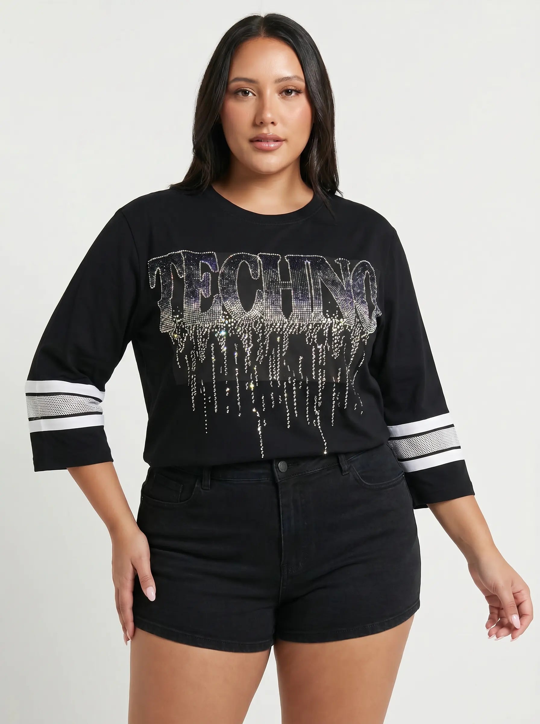 Woman wearing a black sweater with 'TECHNO' text and white sleeves on a plain background, TCH TECHNO Waterfall Rhinestone T-Shirt