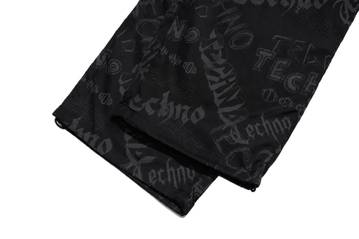 Black fabric accessory with an all-over dark gray Techno logo print, folded to show the texture and pattern on a white background. TCH Techno Logo Wide-Leg Cargo Pants