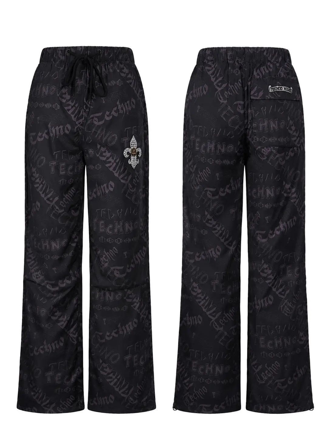 Black wide-leg scrub pants with an all-over gray 'Techno' script pattern, shown from both the front and back views. The front view features a drawstring waist and a small fleur-de-lis logo on the left thigh, while the back view shows a side pocket with a brand label. TCH Techno Logo Wide-Leg Cargo Pants