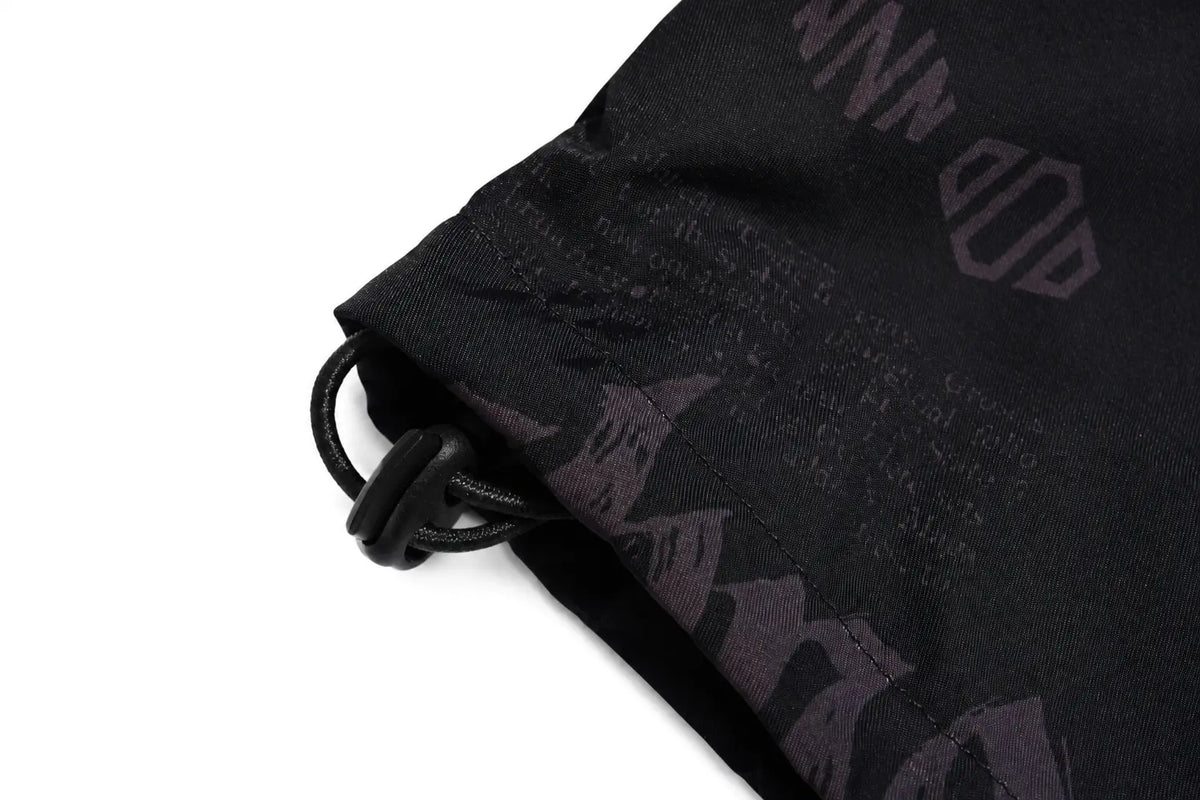 Close-up of a black drawstring bag or pouch with a black cord and plastic toggle, featuring a subtle dark gray graphic pattern on a white background. TCH Techno Logo Wide-Leg Cargo Pants