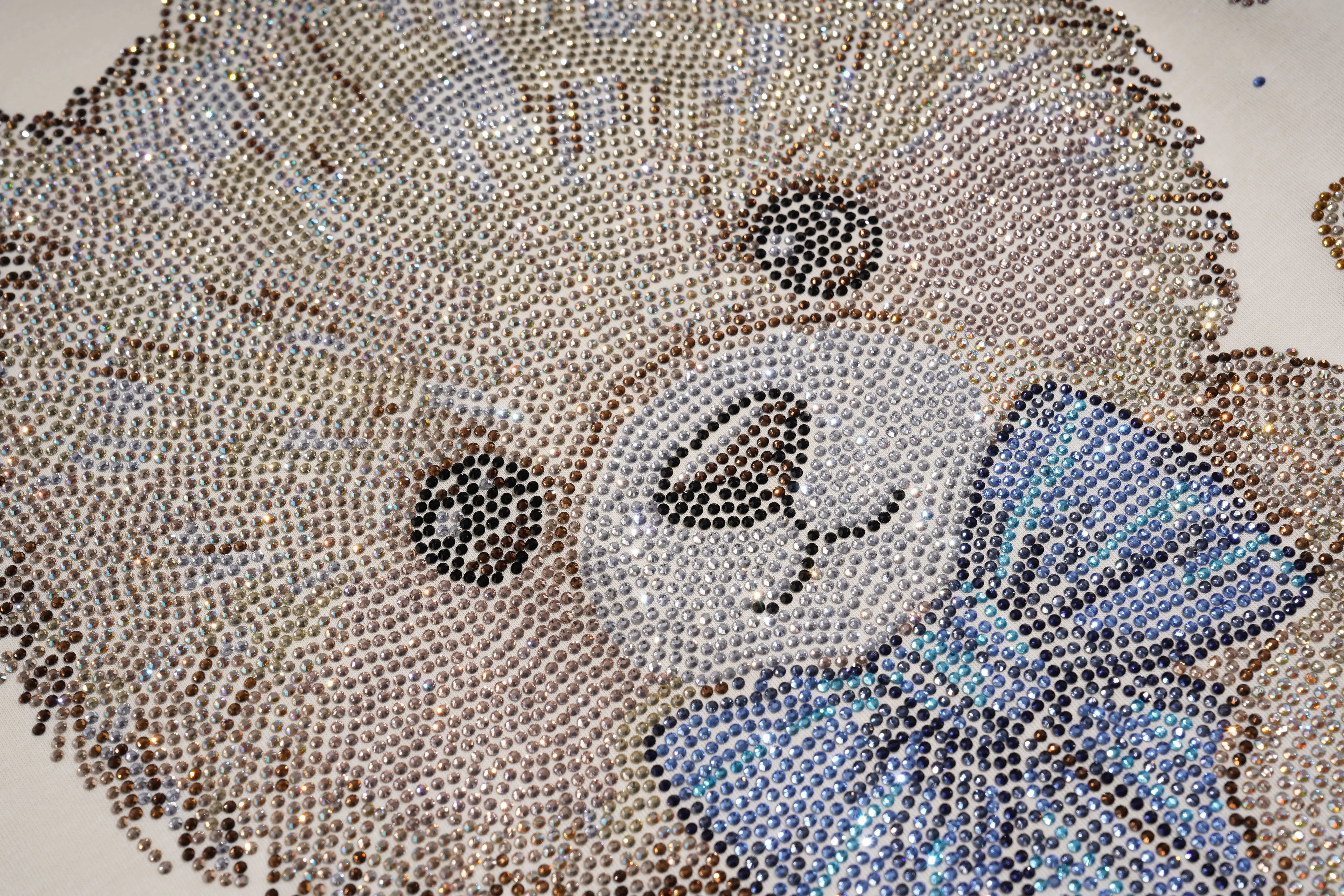 Close-up of a decorative item with intricate patterns and a blue bow. TCH Teddy Bear Garden Rhinestone Lounge Set
