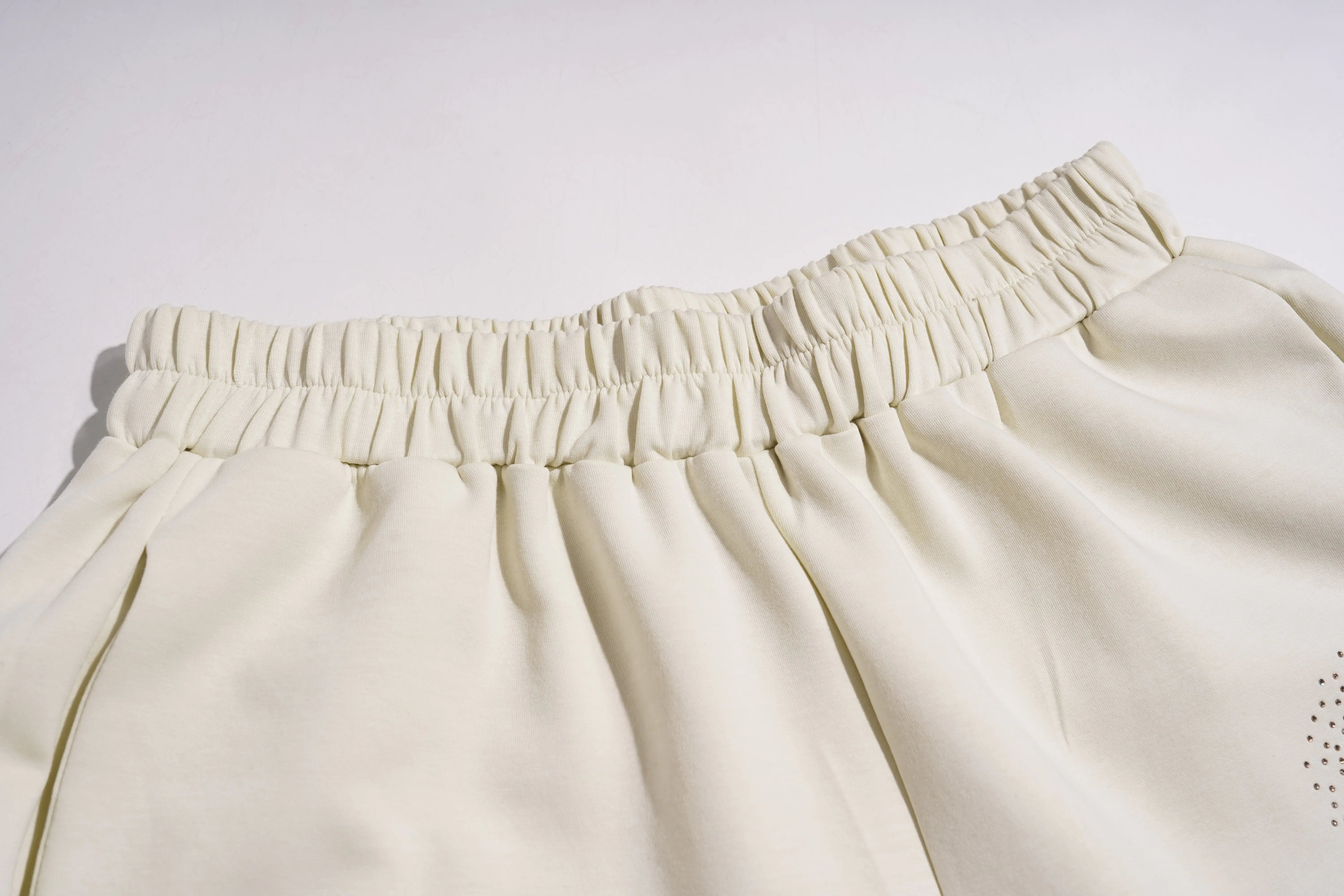 Close-up of beige pants with an elastic waistband on a white background, TCH Teddy Bear Garden Rhinestone Lounge Set