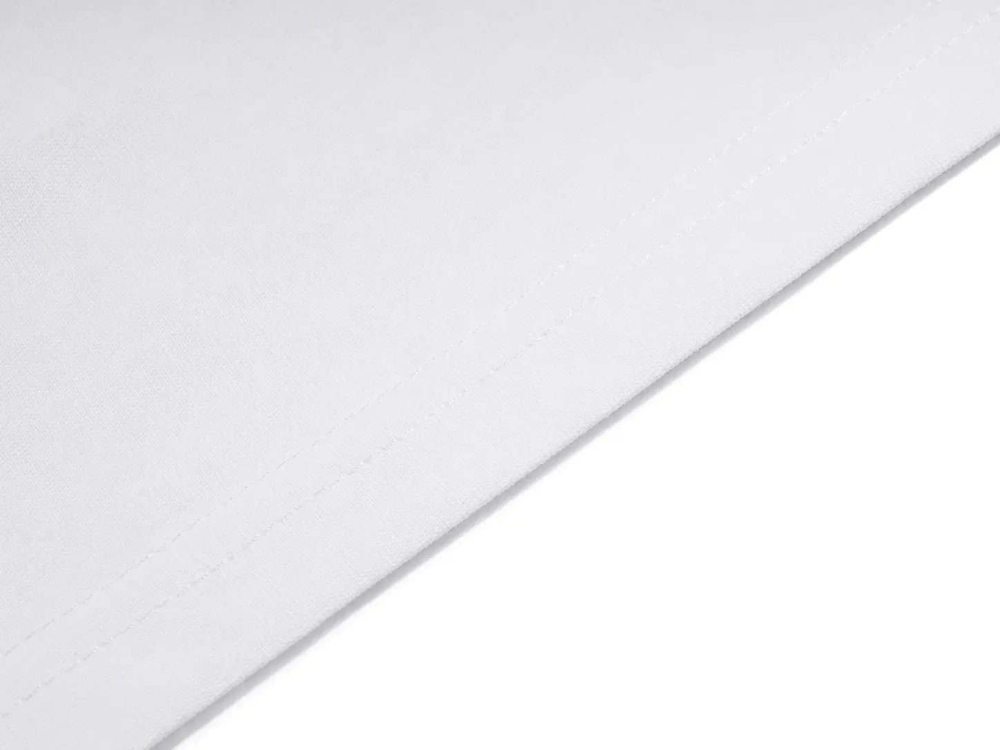 A close-up of a white textured fabric or material surface with a diagonal seam or edge running across the frame. TCH Unicorn Rhinestone Angel Wings Oversized White T-Shirt