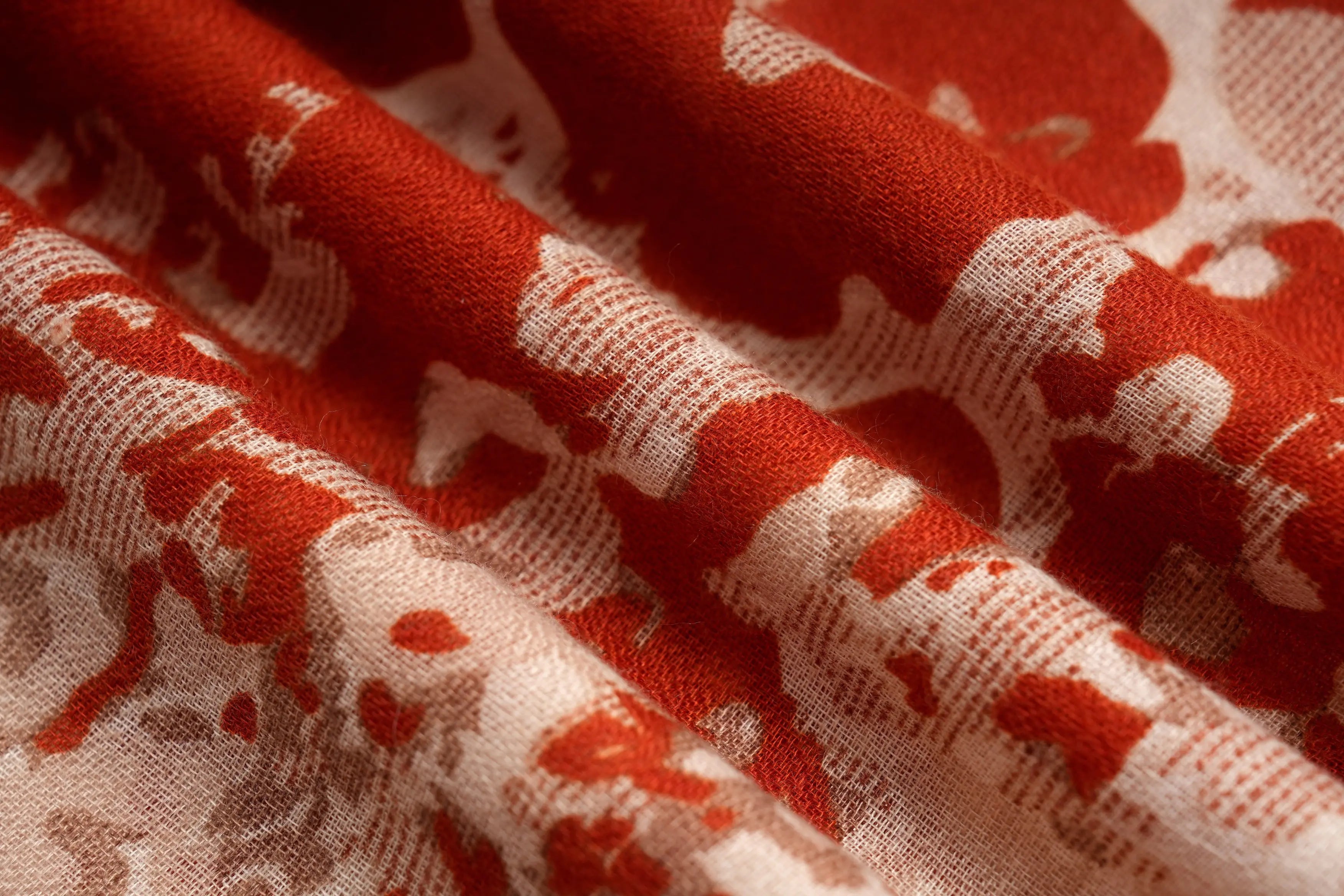A close-up of draped fabric with a red and cream abstract floral or damask pattern, showing the texture and folds of the material. TCH Vintage Leopard Print Lightweight Fashion Scarf