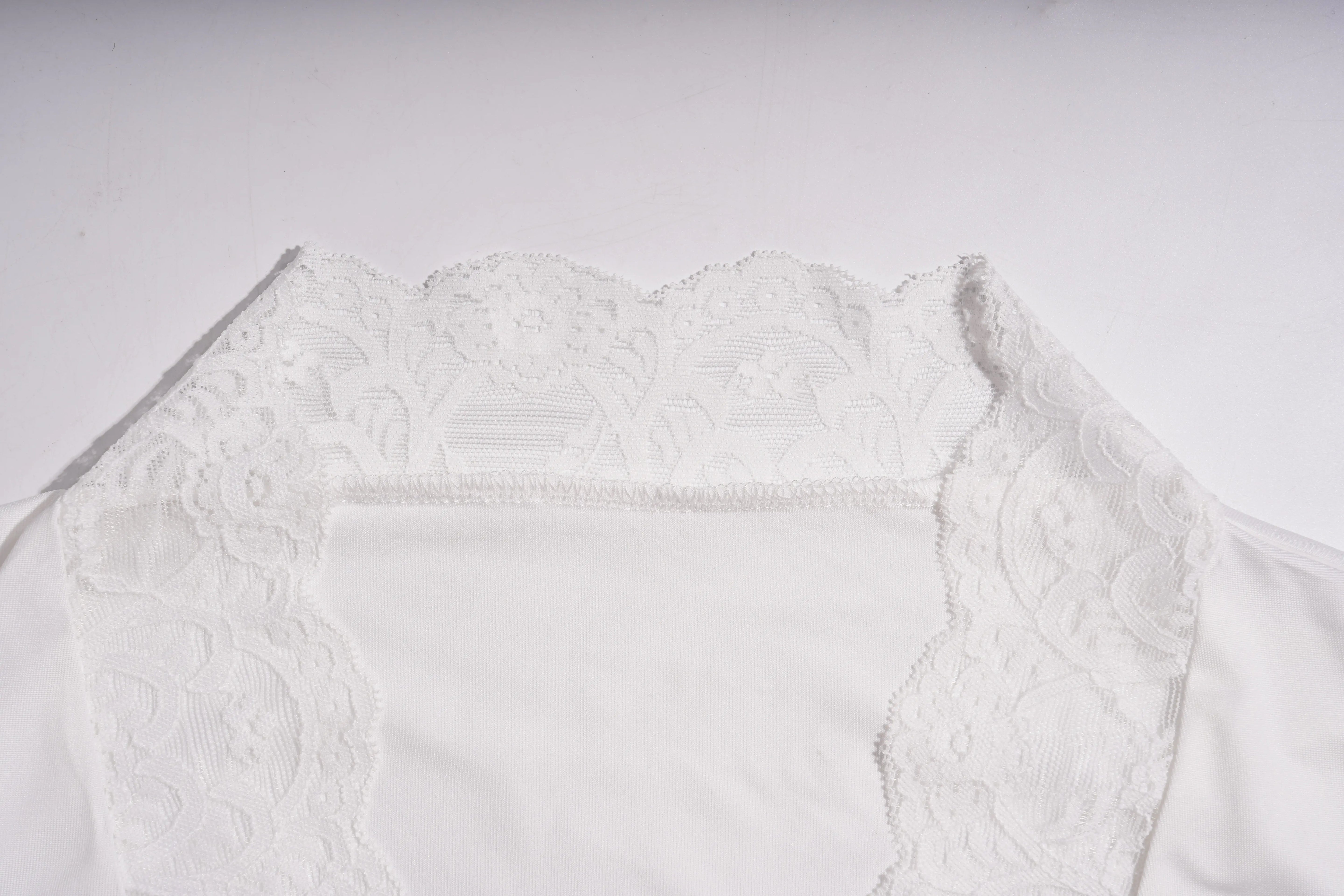 White lace garment on a light gray background, TCH White Lace Trim V-Neck Rhinestone Wing Long Sleeve Top