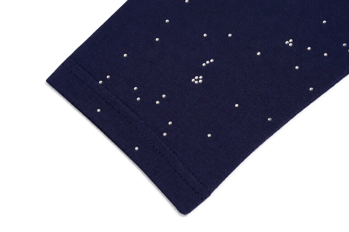 Close-up of a navy blue fabric item, likely a garment sleeve or cuff, decorated with small white rhinestones arranged in a scattered pattern, shown on a plain white background. TCH Winged Unicorn Starry Rhinestone Long Sleeve T-Shirt