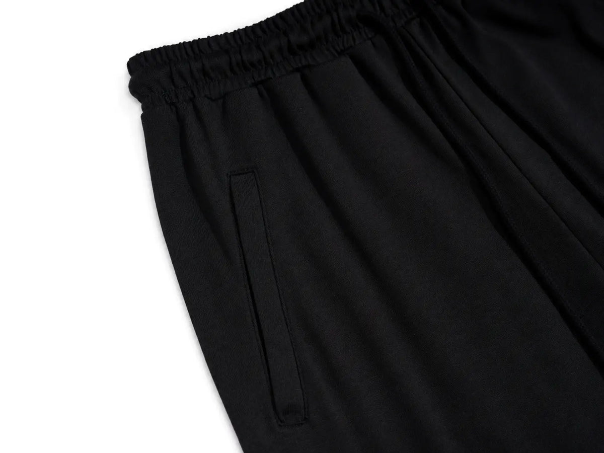 Close-up of black elastic-waist pants showing a side pocket and fabric texture against a white background. TCH Women’s Black Wide-Leg Sweatpants with Rhinestone Star Graphic