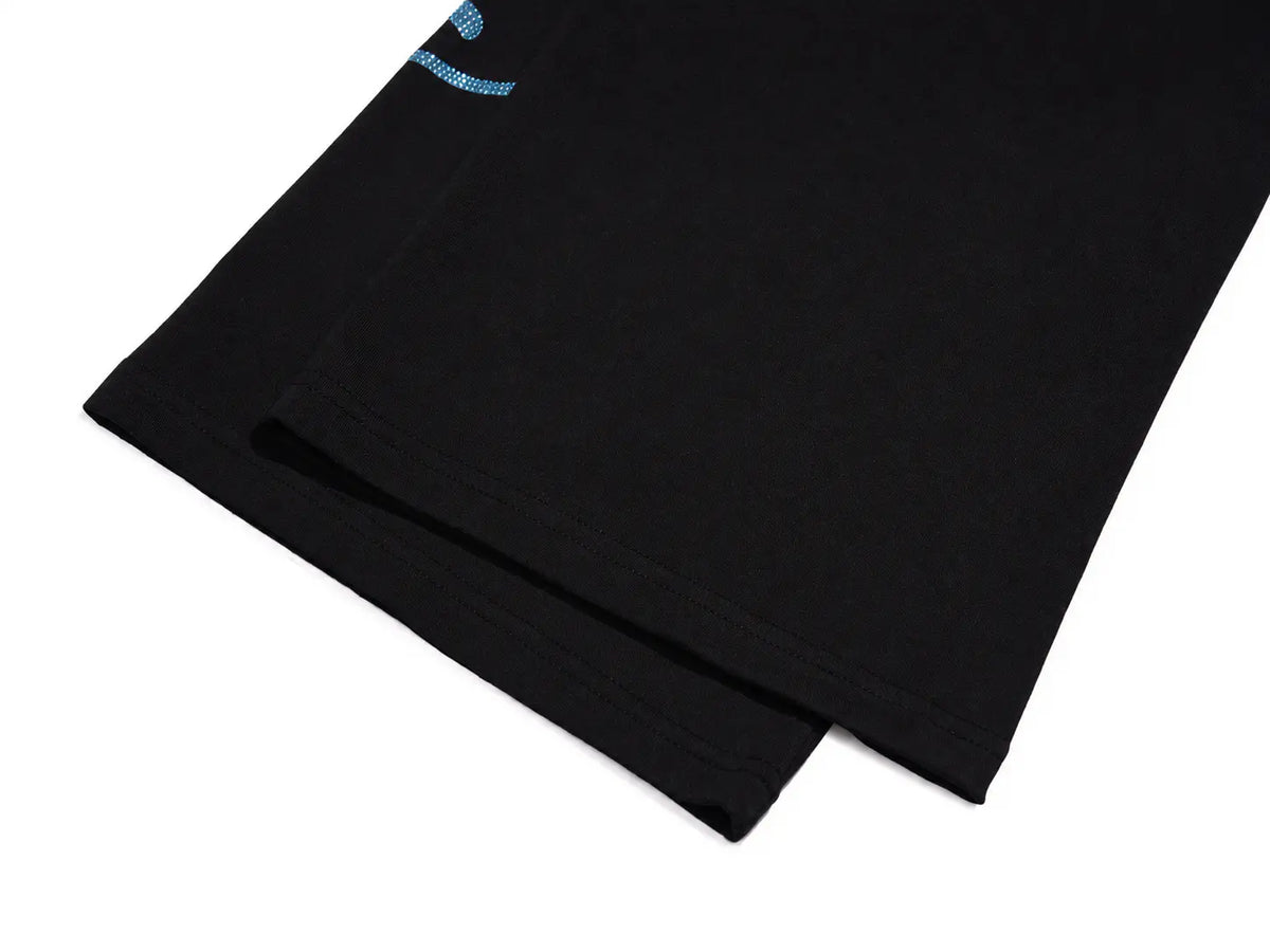 A close-up of a black folded garment, likely a sweatshirt or jacket sleeve, showing a small light blue embroidered logo near the top edge, set against a plain white background. TCH Women’s Black Wide-Leg Sweatpants with Rhinestone Star Graphic