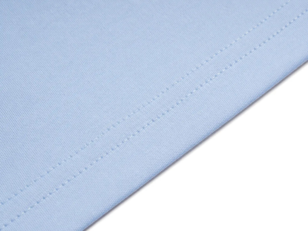 A close-up of light blue fabric with fine diagonal stitching, shown against a white background. TCH Women's Blue Teddy Bear Graphic Oversized T-Shirt