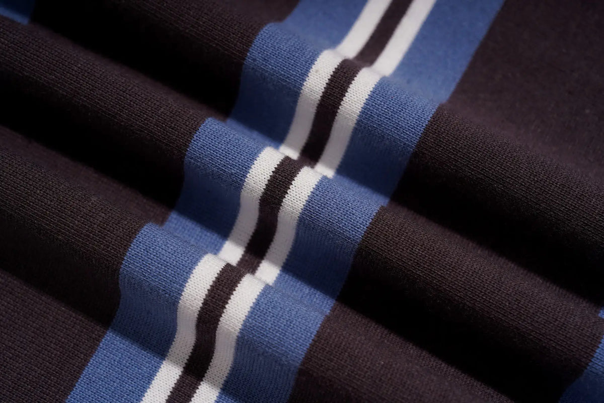 A close-up of a ribbed knit fabric with a striped pattern in dark brown, medium blue, white, and thin black lines. TCH Women's Striped Polo Mini Dress