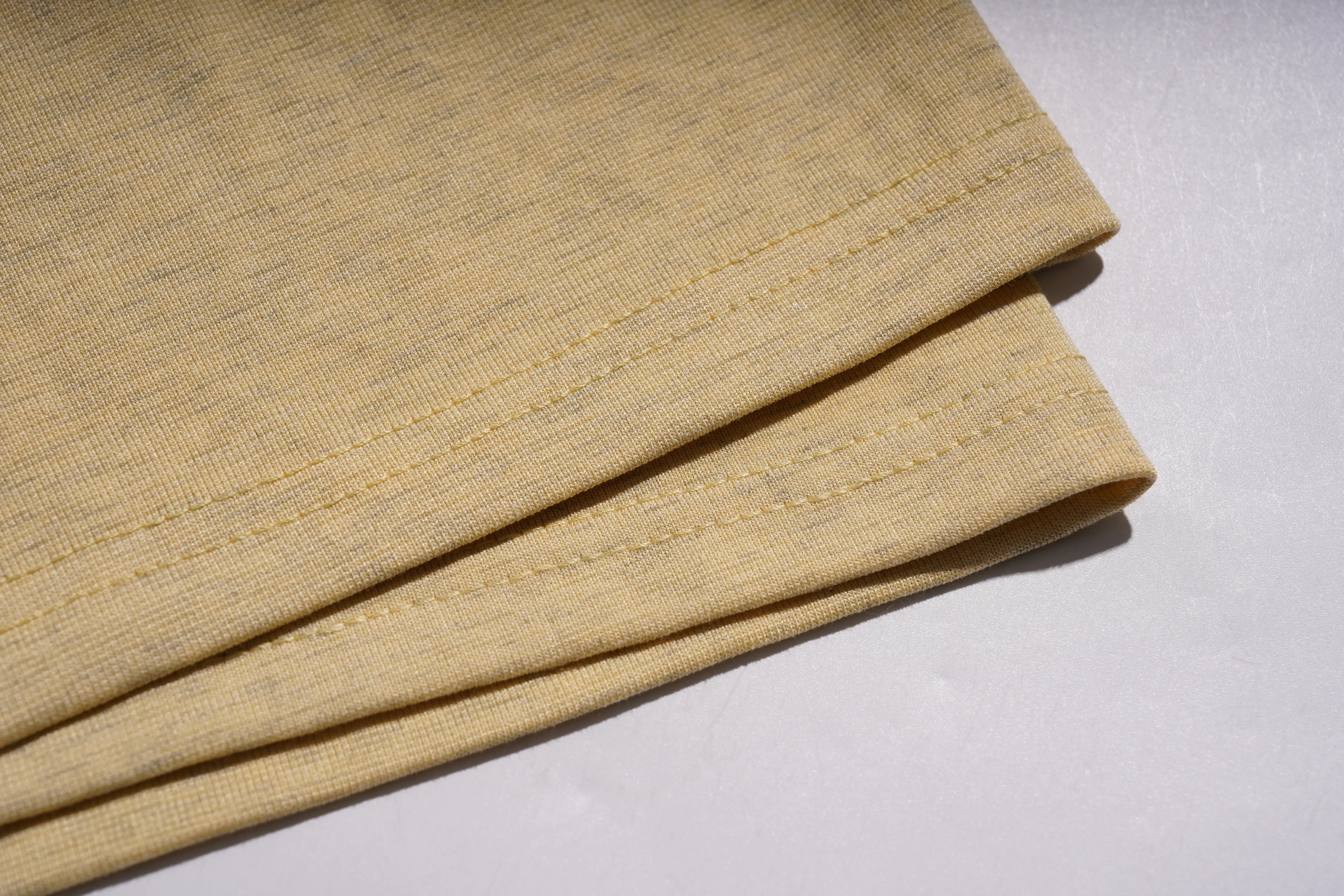 Folded beige fabric on a light gray background, TCH Yellow Butterfly Pajama Set